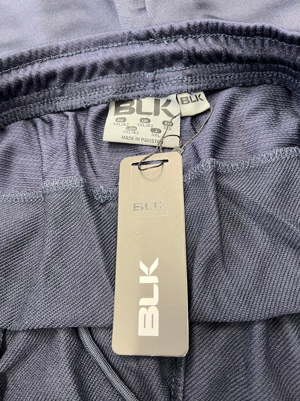 Close-up of BLK brand label and elastic waistband inside London Irish tracksuit trousers