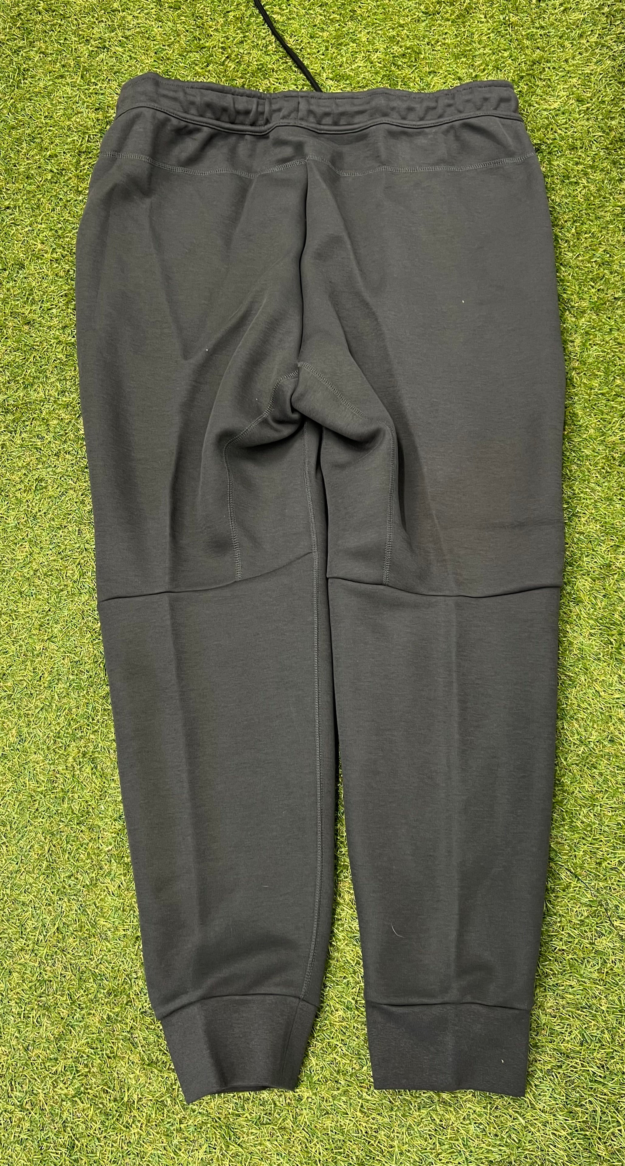 Back view of Nike Liverpool FC men's dark grey tracksuit trousers showing elastic waistband and ribbed cuffs