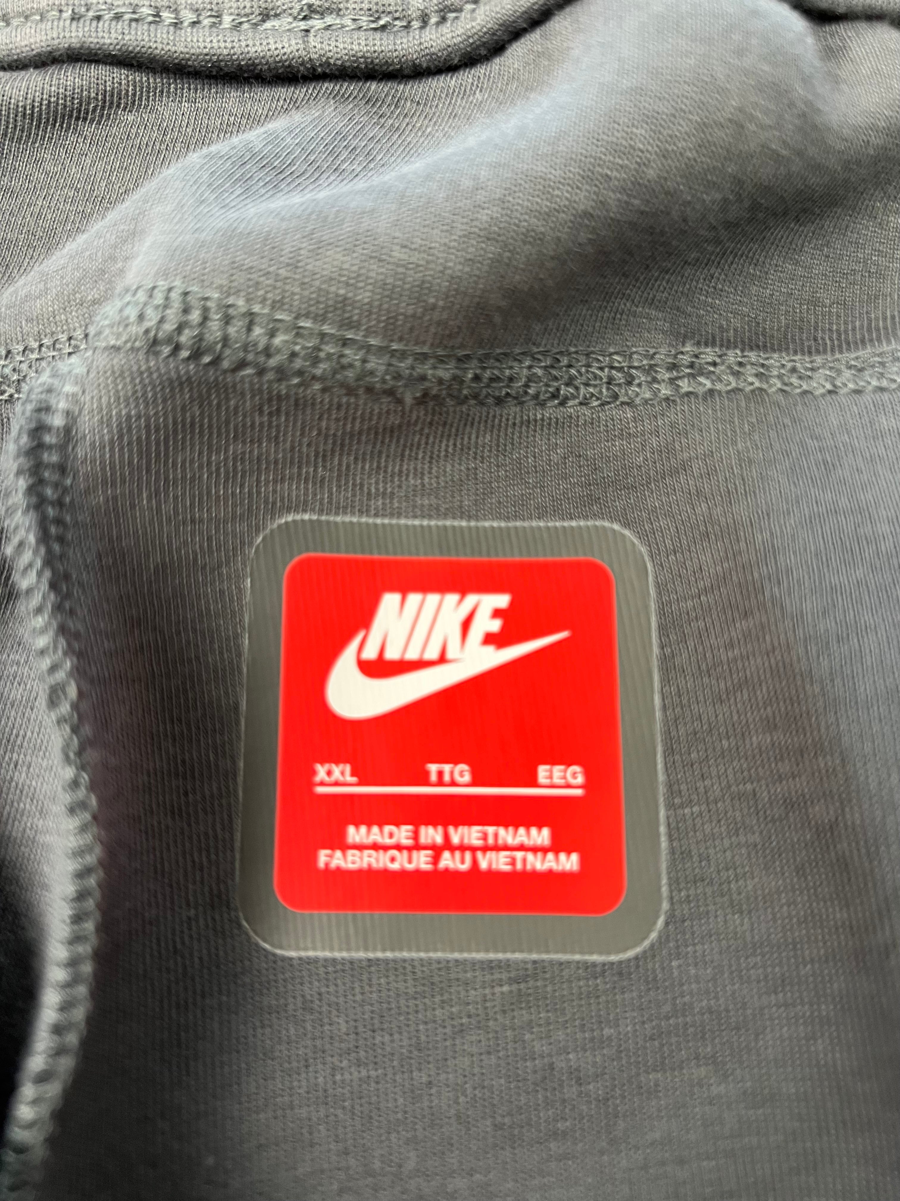 Close-up of Nike label inside waistband showing size XXL and made in Vietnam