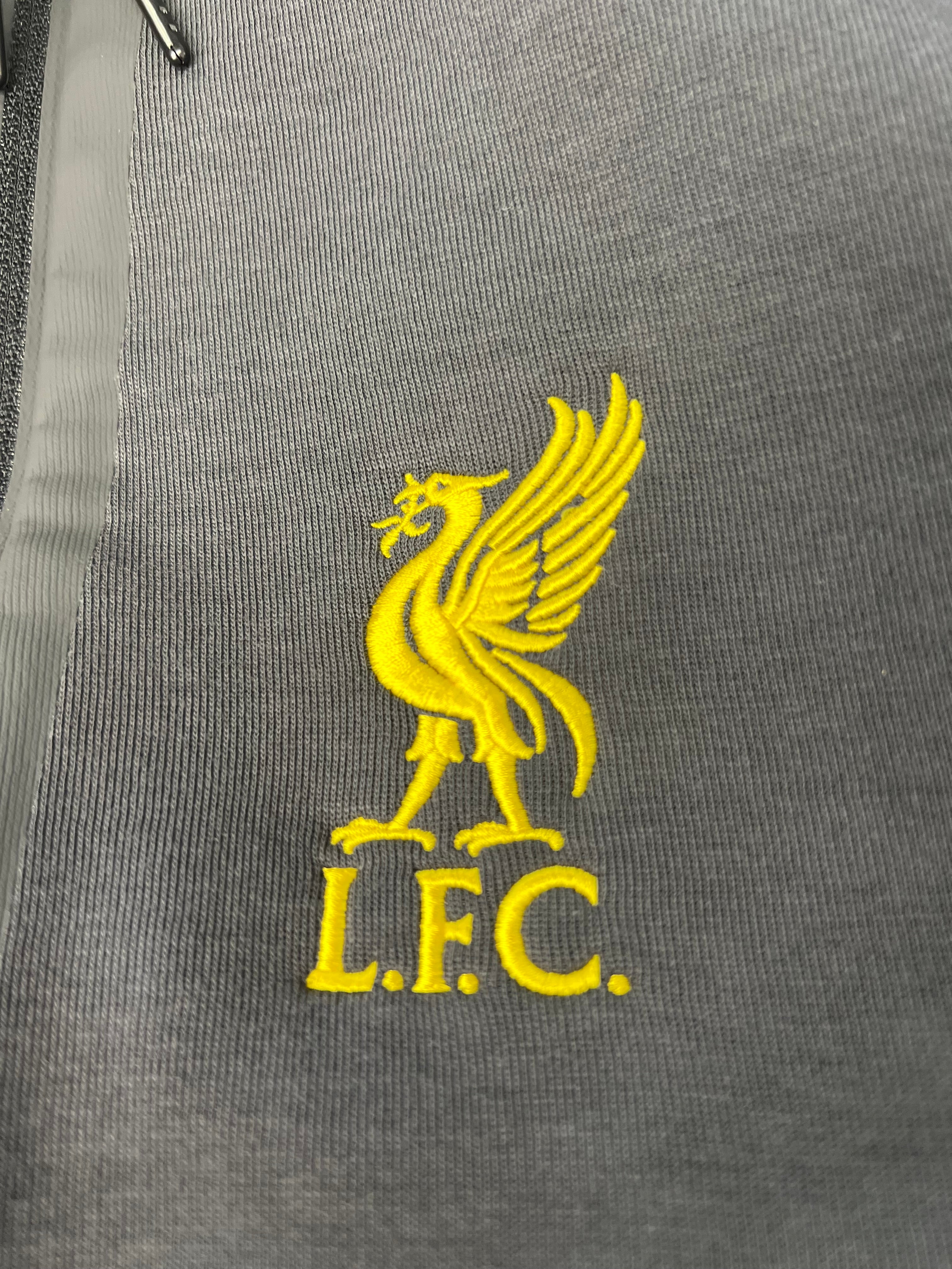 Close-up of yellow embroidered Liverpool FC liver bird logo on trousers
