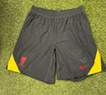 Front view of Nike Liverpool FC men's football shorts in black with red and yellow accents