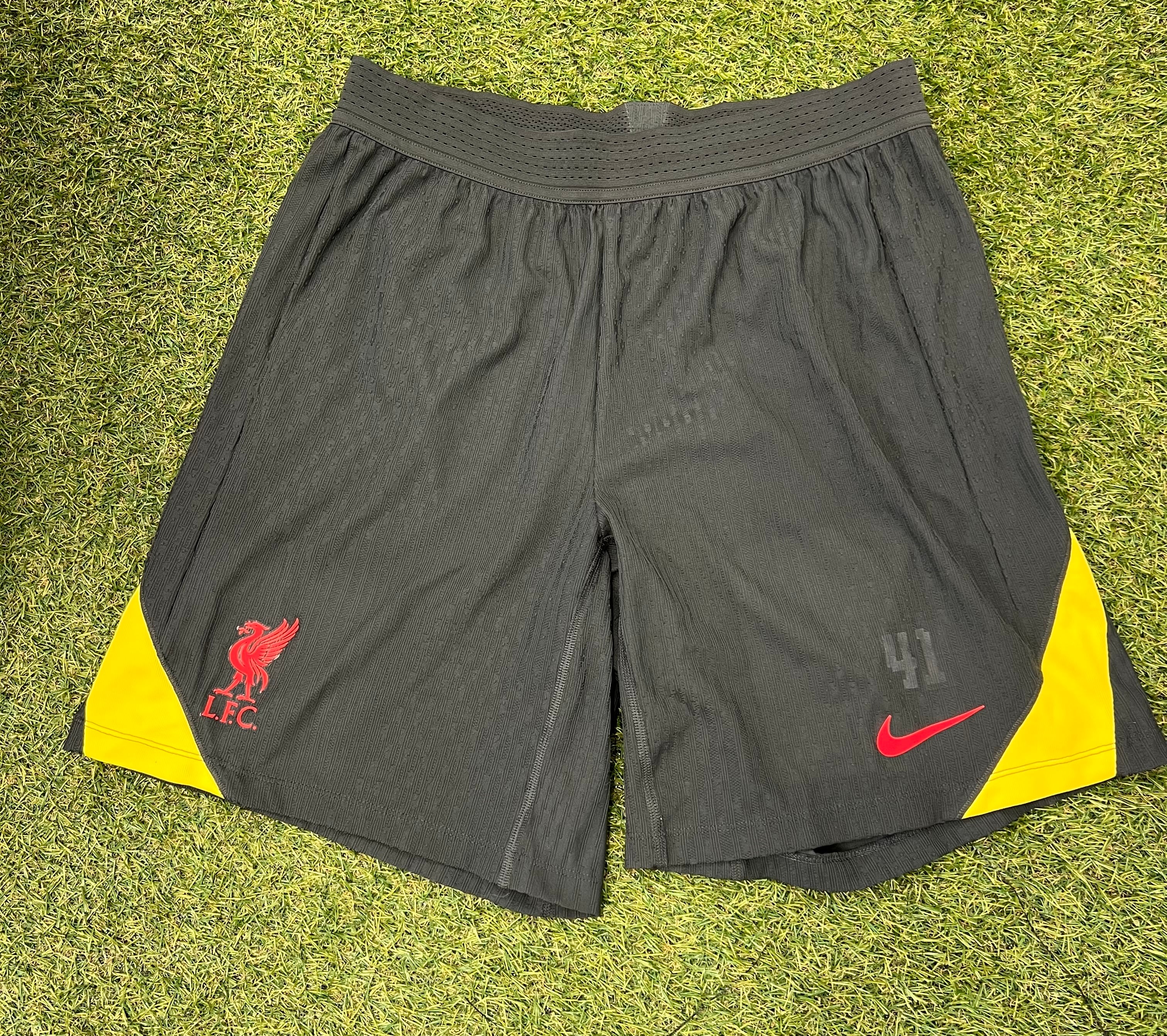 Front view of Nike Liverpool FC men's football shorts in black with red and yellow accents