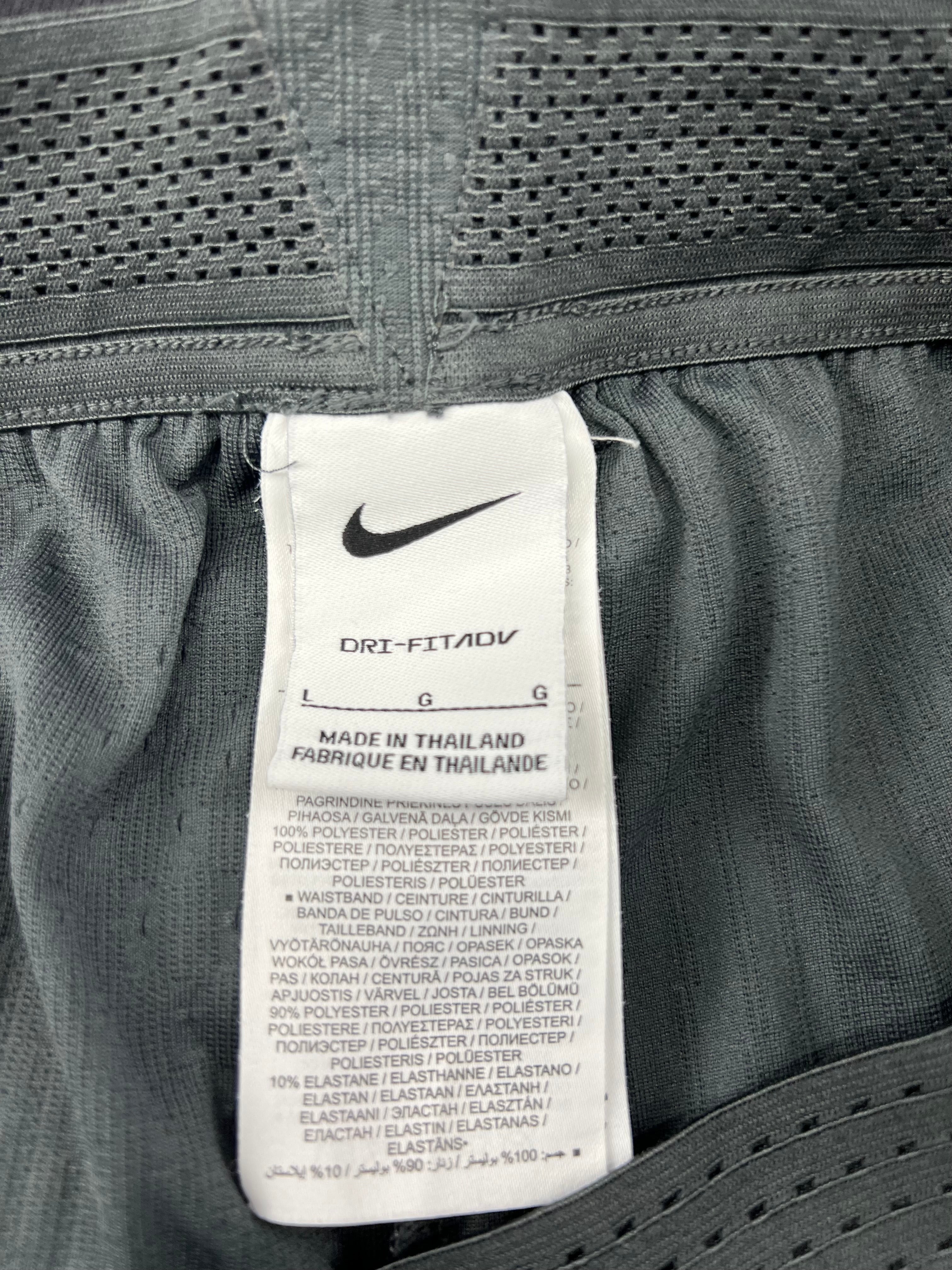 Close-up of the shorts waistband label showing Nike Dri-FITADV fabric composition and care details