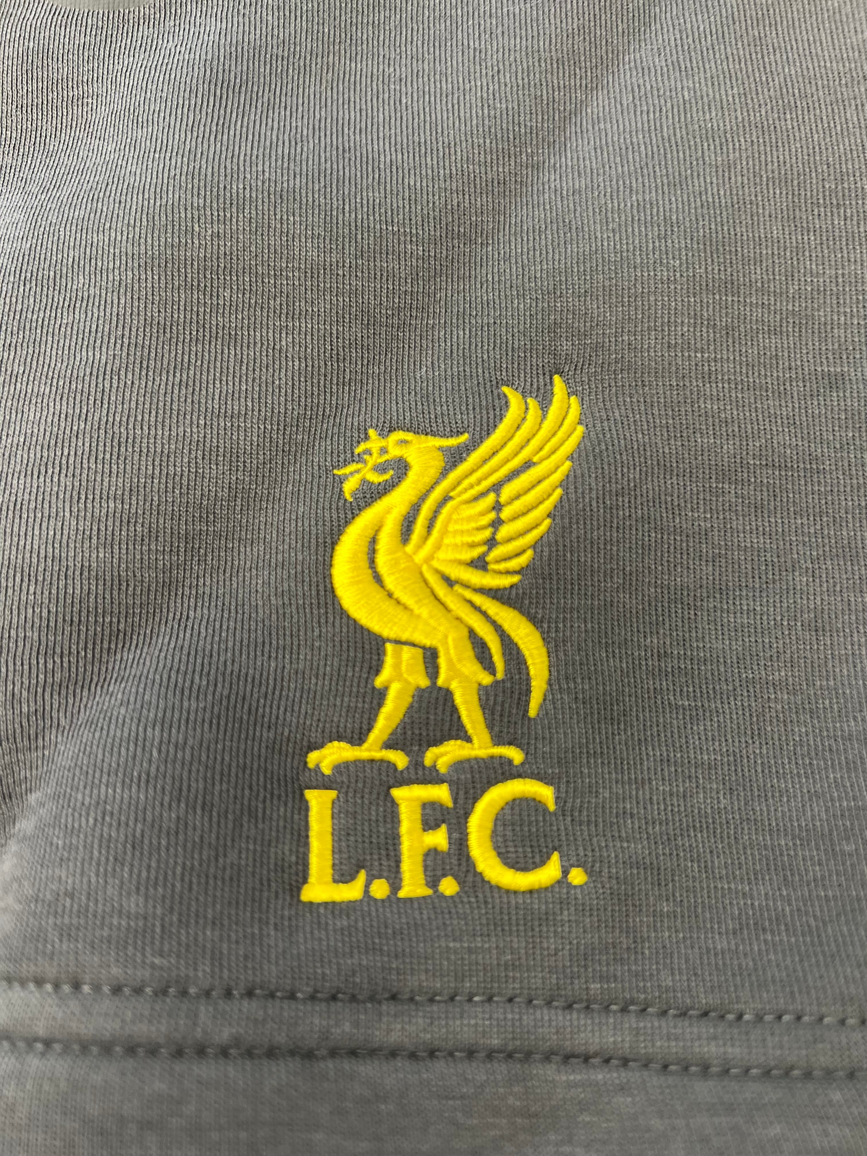 Close-up of yellow embroidered Liverpool FC crest on black Nike shorts