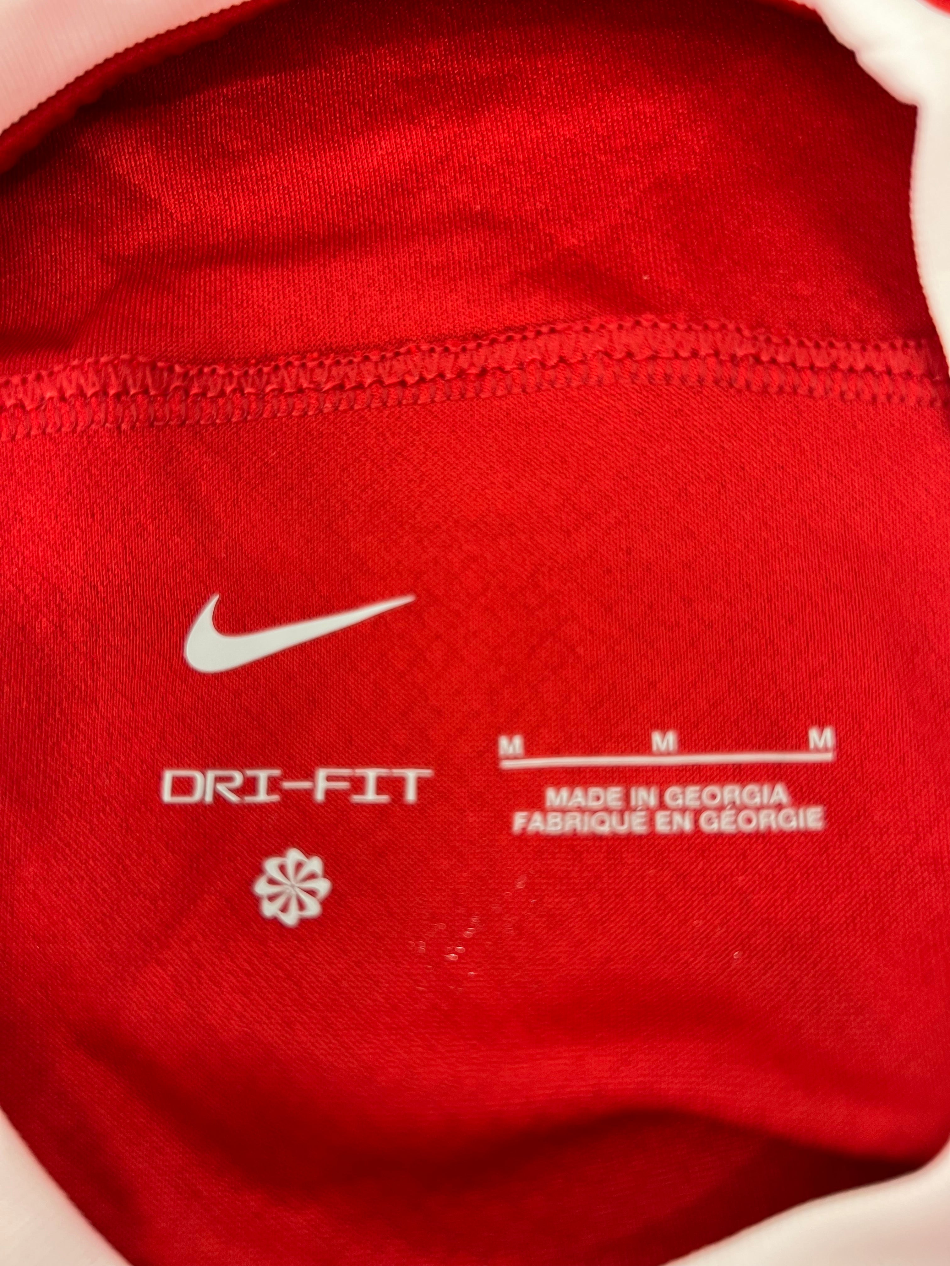 Inside label of Liverpool FC jersey showing Nike logo, size M, and made in Georgia