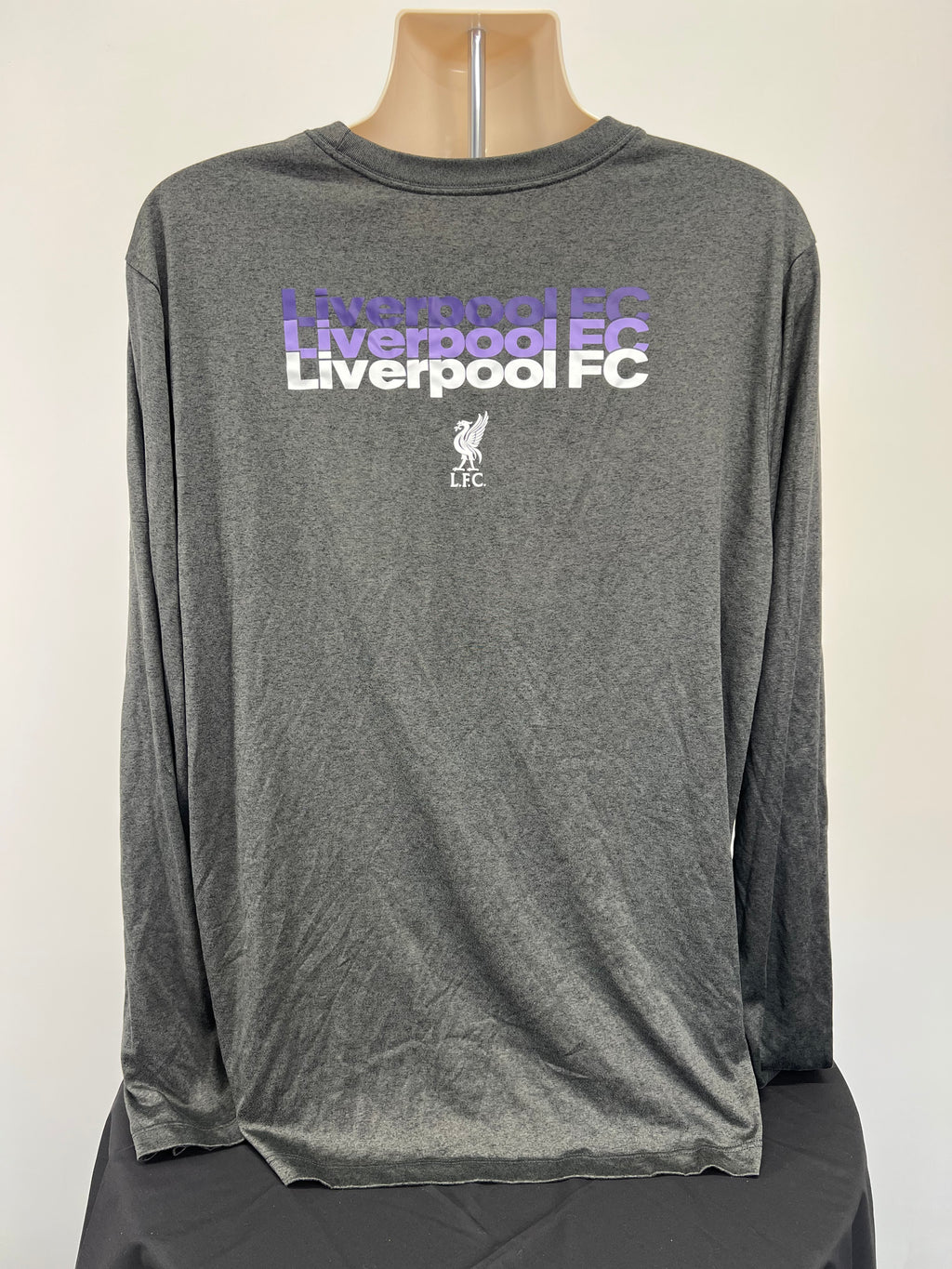 Back view of men's grey Nike Liverpool FC long sleeve training top featuring repeated Liverpool FC text and emblem