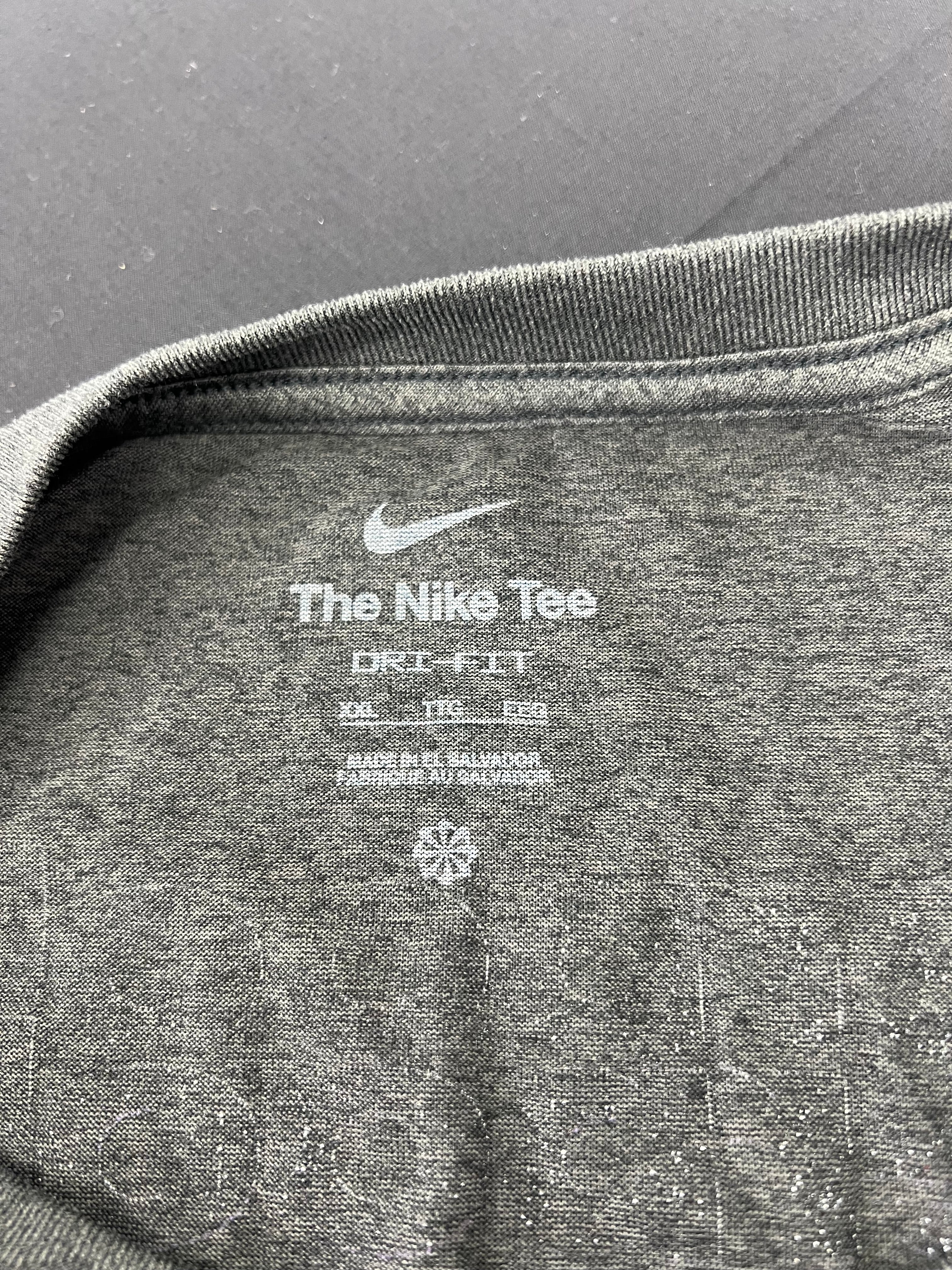 Close-up of the inner neck label of men's Nike Dri-Fit long sleeve training top