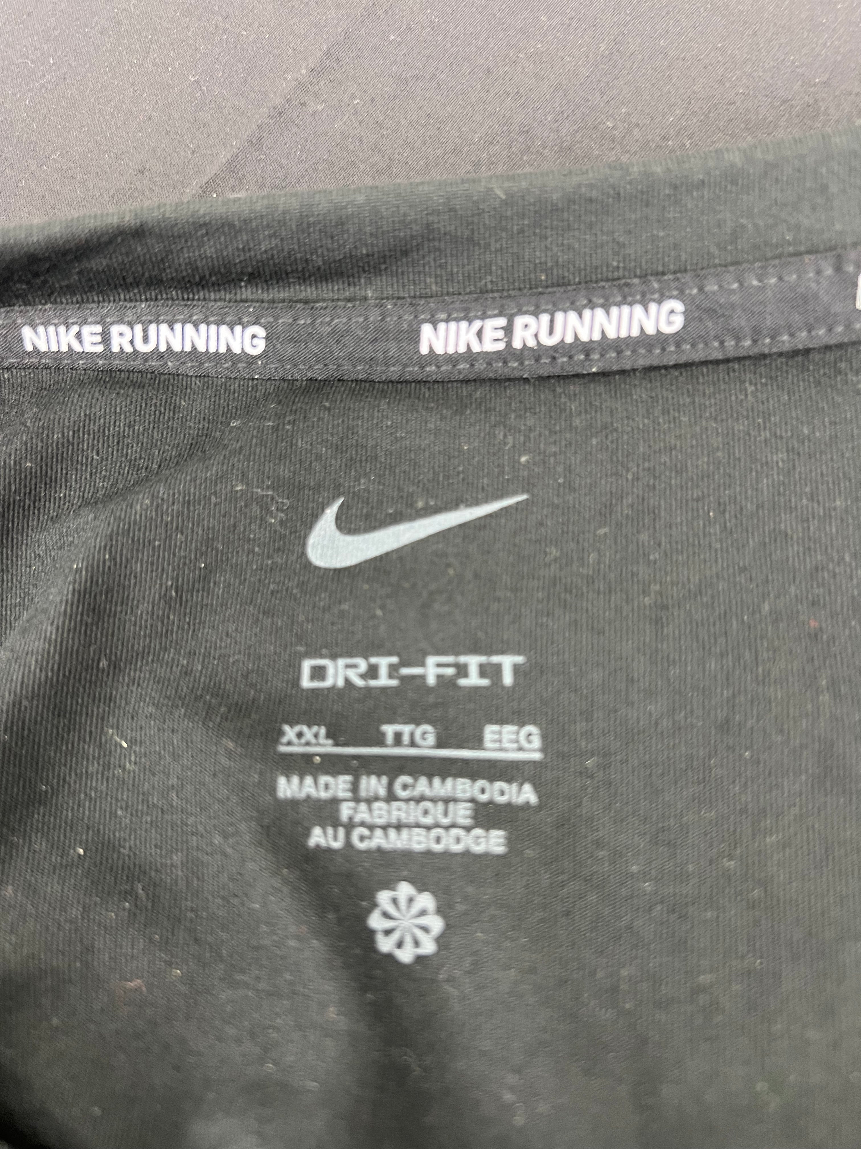 Close-up of neckline inside tag showing Nike Running text and Dri-Fit branding on Liverpool FC training top