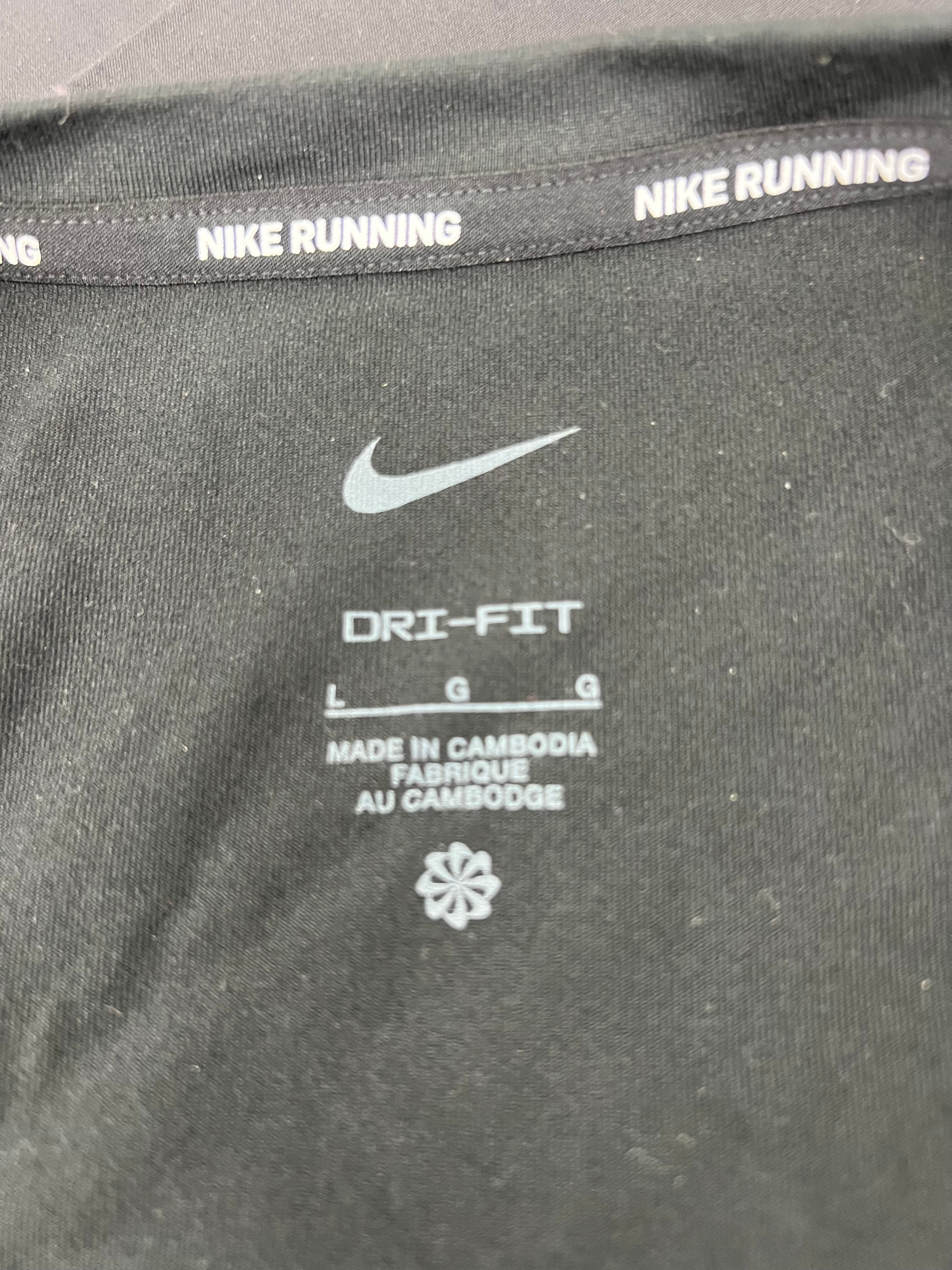 Inside label showing Nike logo, Dri-FIT technology and size L on black training top