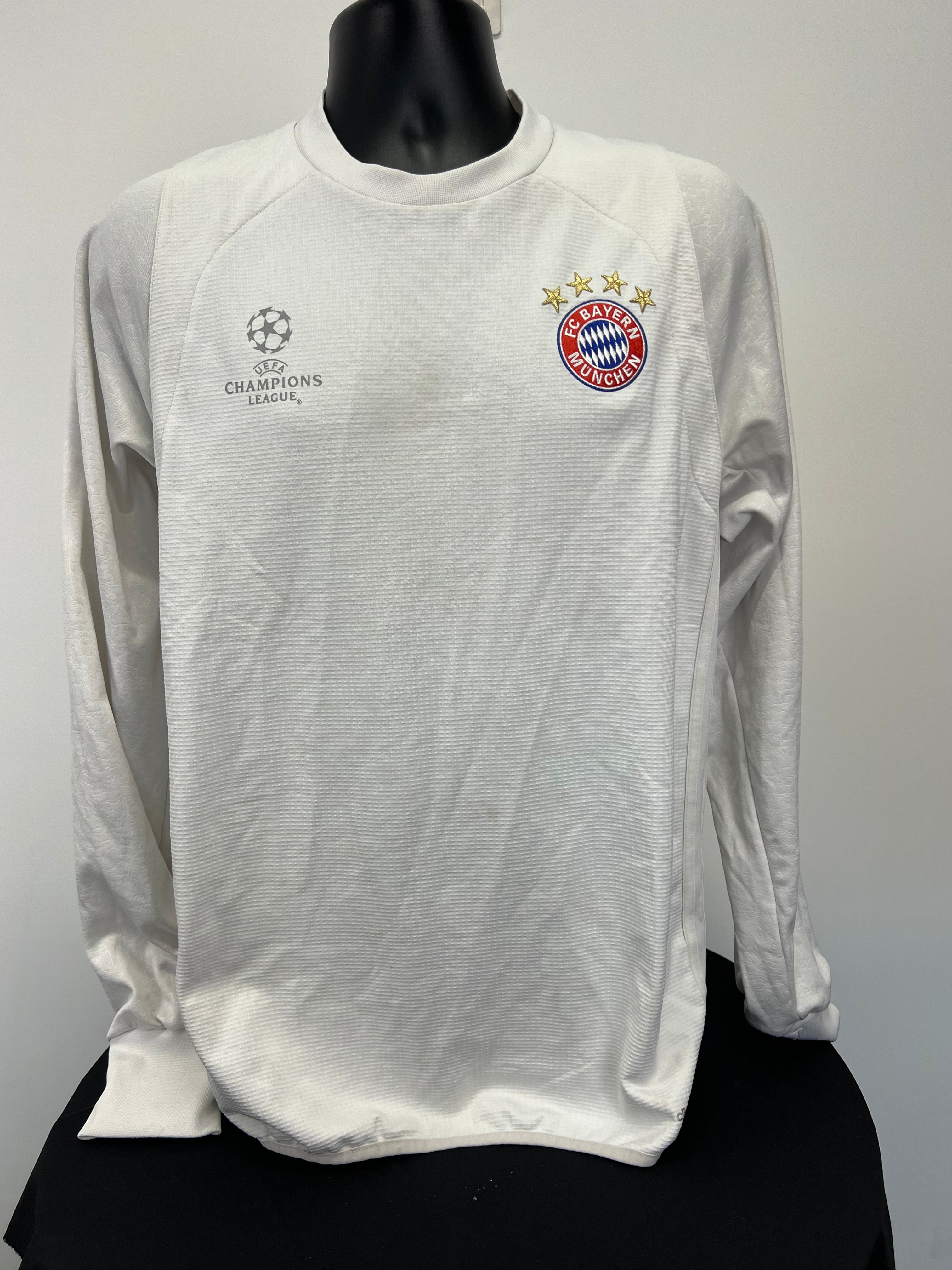 Front view of Adidas FC Bayern Munich white long sleeve top with UEFA Champions League and team logos