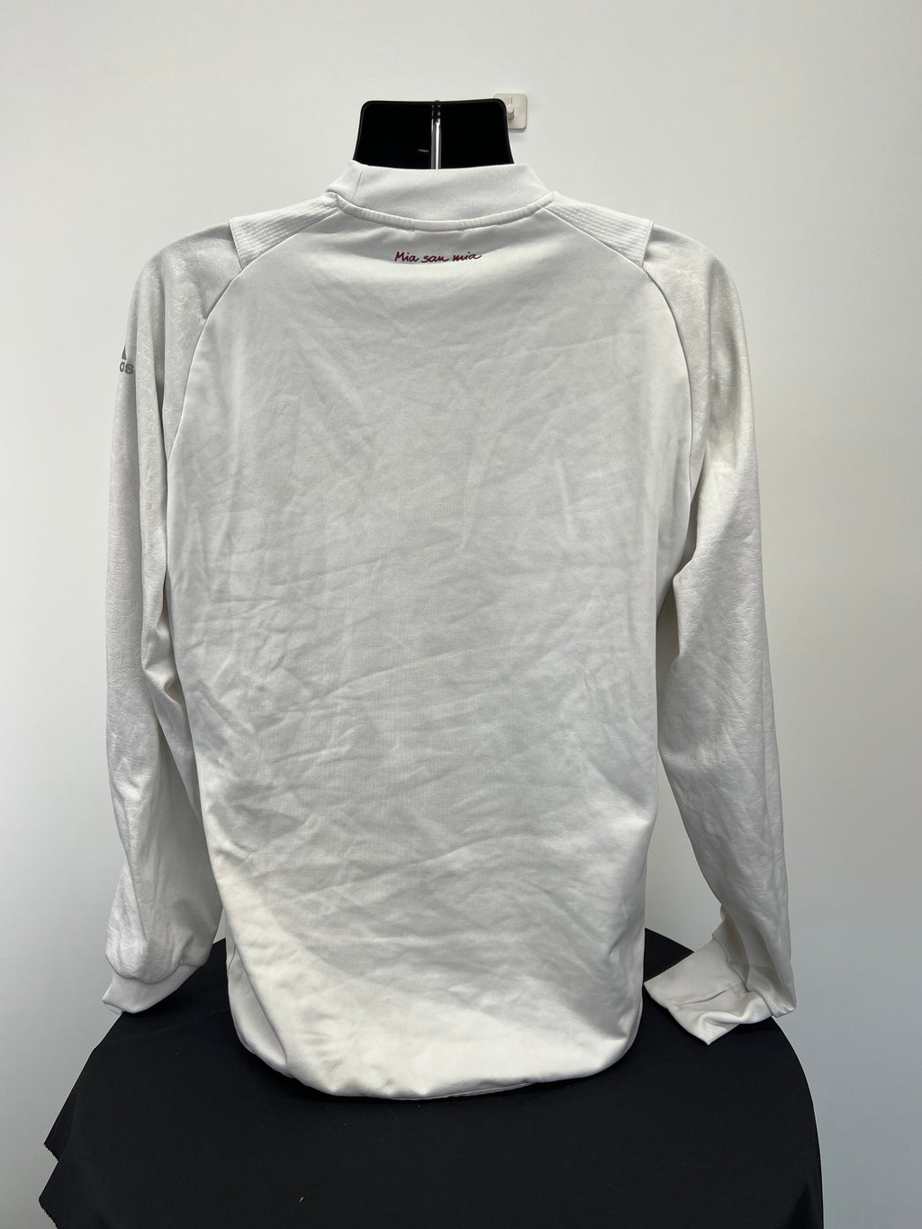 Back view of Adidas FC Bayern Munich white long sleeve top with 'Mia san mia' text