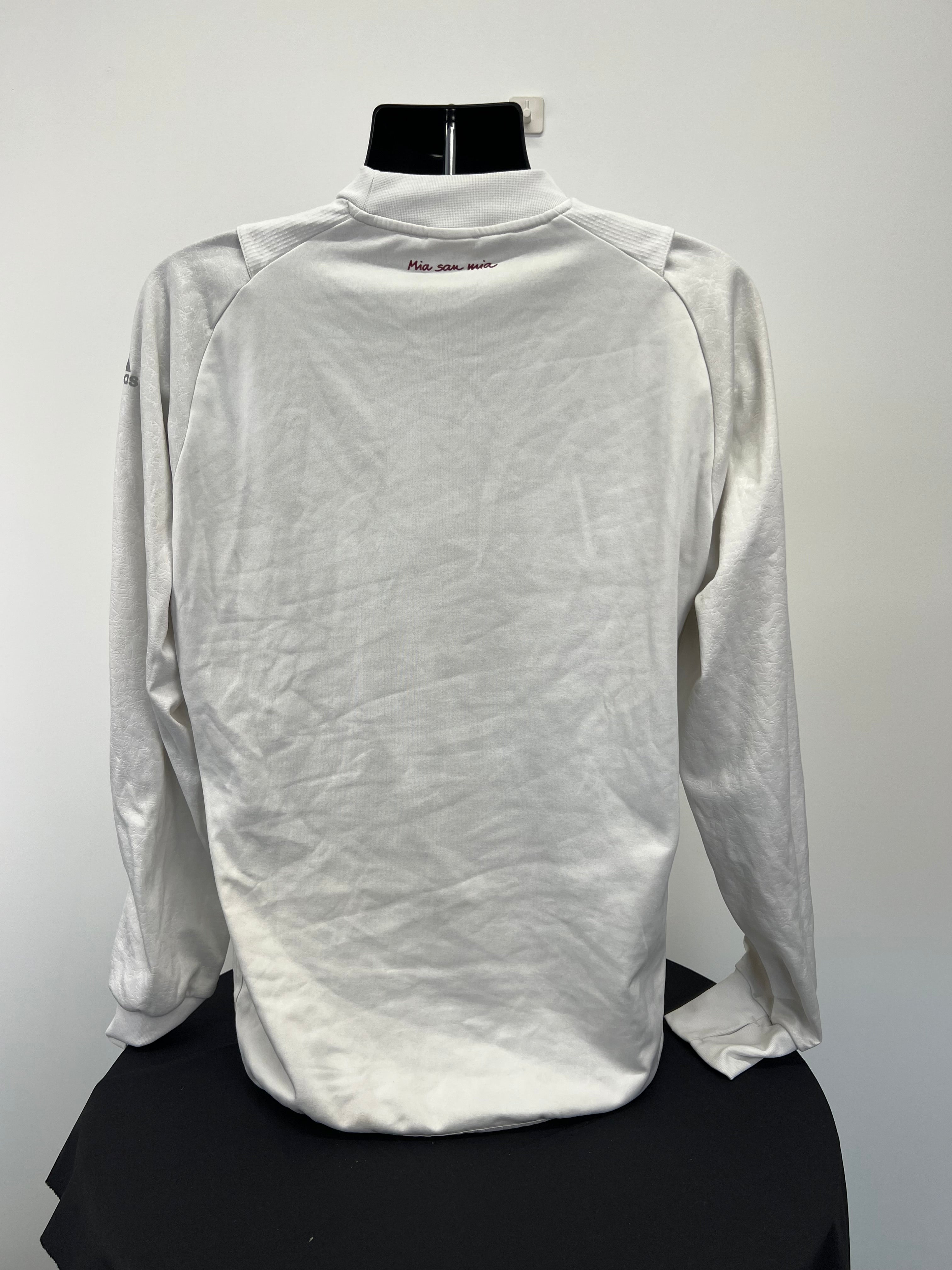 Back view of Adidas FC Bayern Munich white long sleeve top with 'Mia san mia' text
