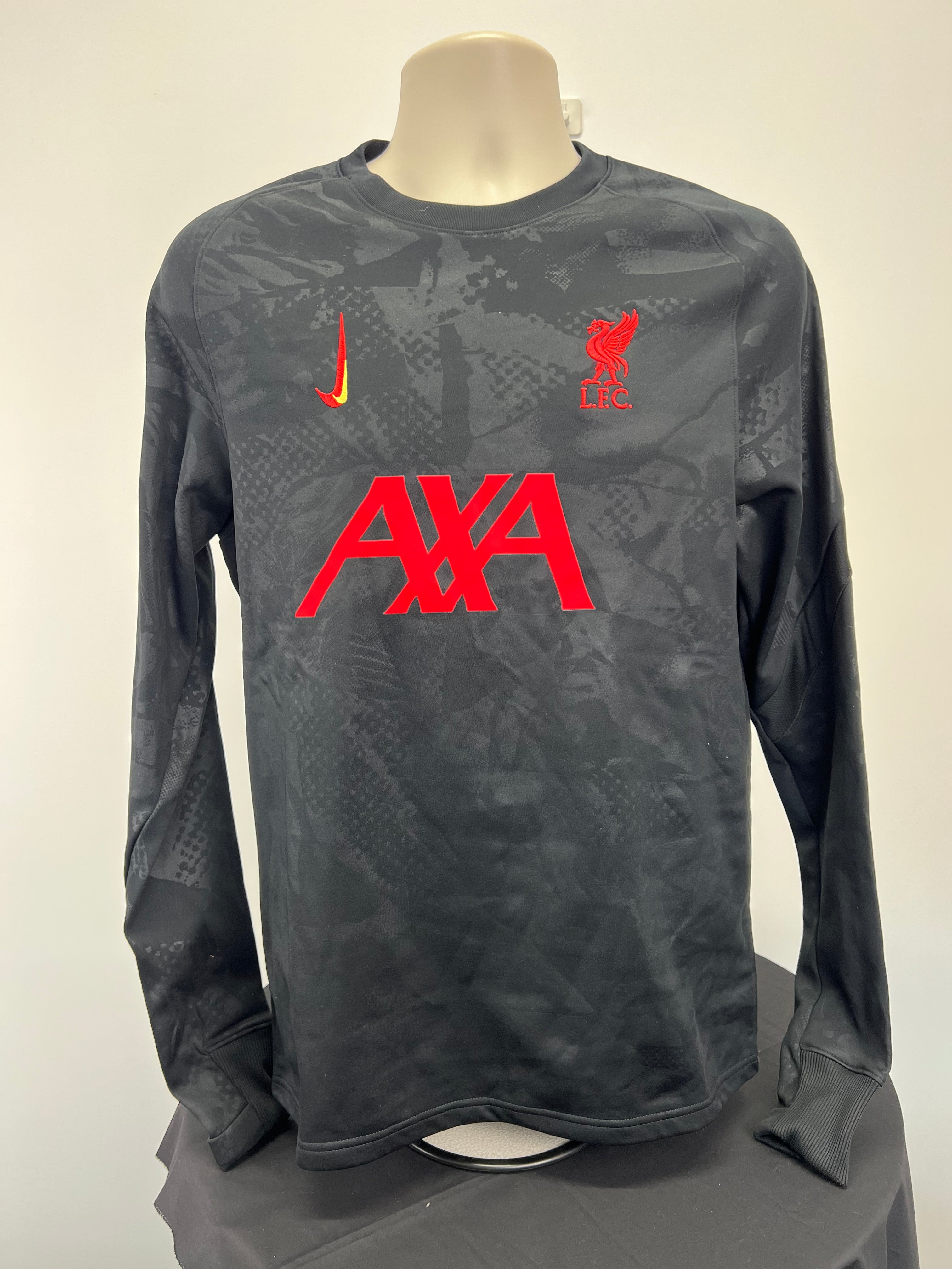 Front view of Nike Liverpool FC long sleeve training top with red logos and subtle dark pattern