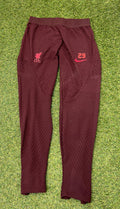 Front view of Liverpool FC Nike maroon Dri-FIT ADV training bottoms with LFC crest and squad number