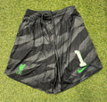 Front view of black patterned Liverpool FC Nike Dri-FIT shorts with green club crest and number one