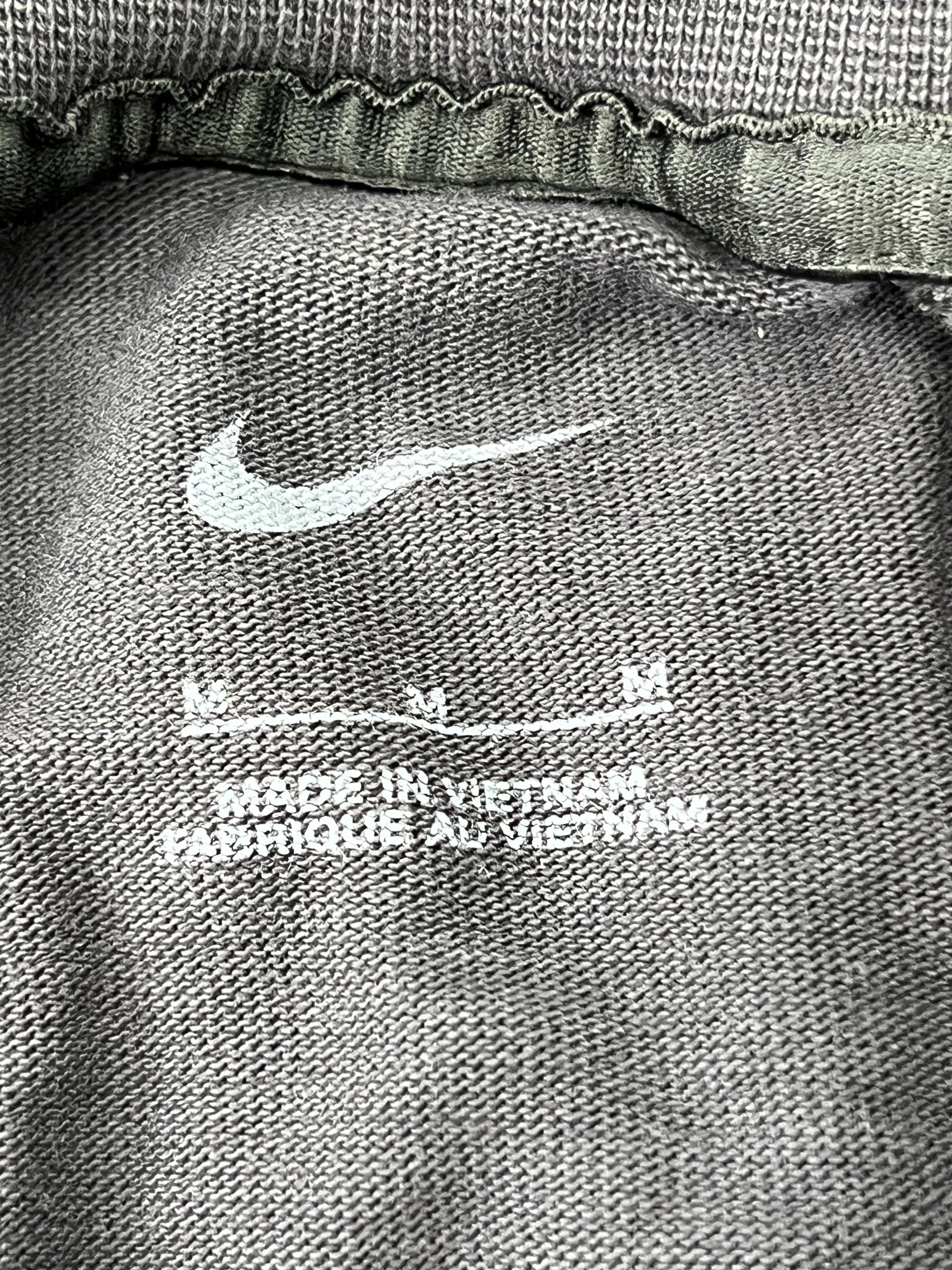 Close-up of Nike logo and fabric texture inside Liverpool FC t-shirt showing made in Vietnam label