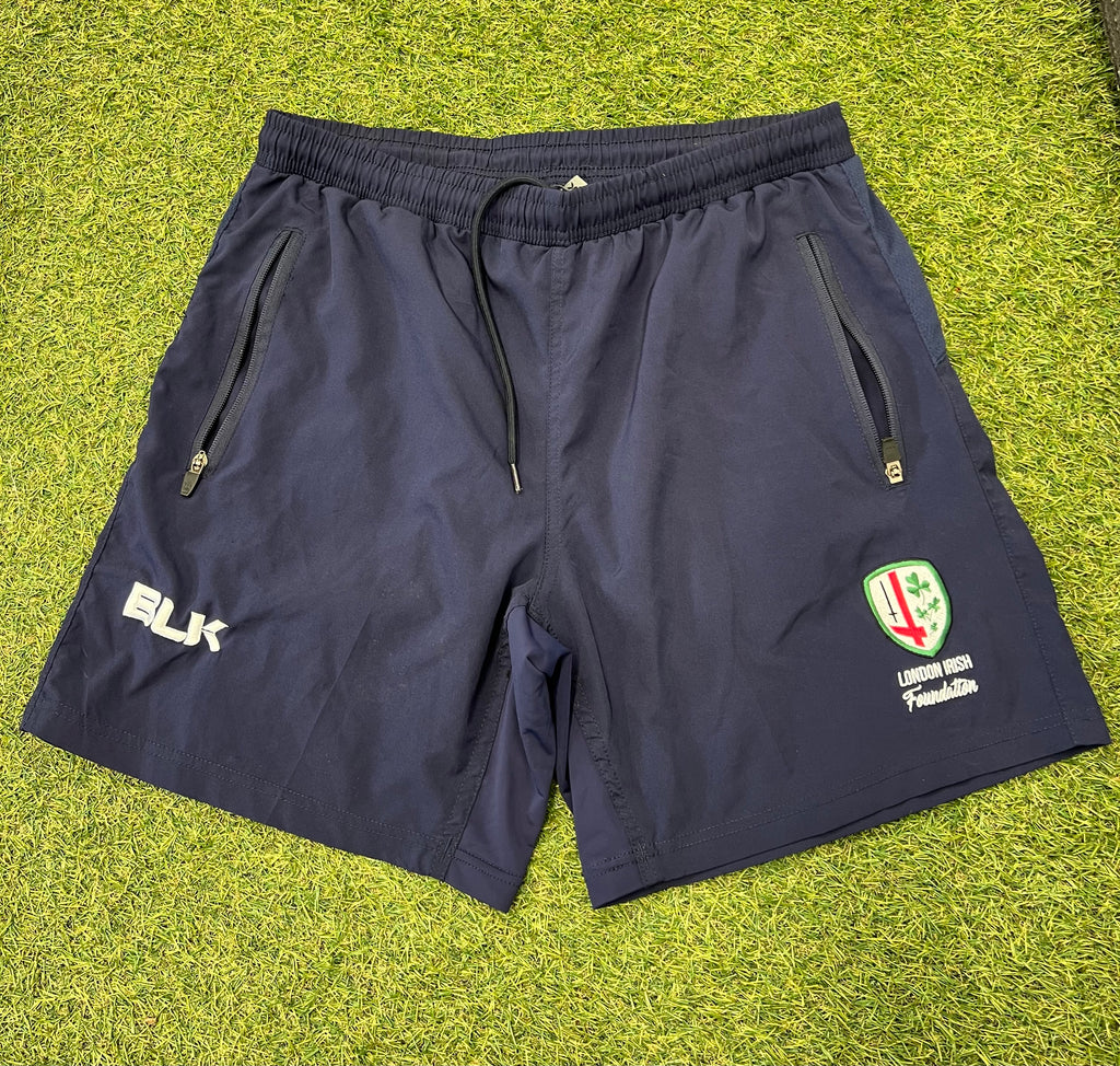 Front view of navy blue London Irish men's training shorts by BLK featuring zip pockets and team emblem