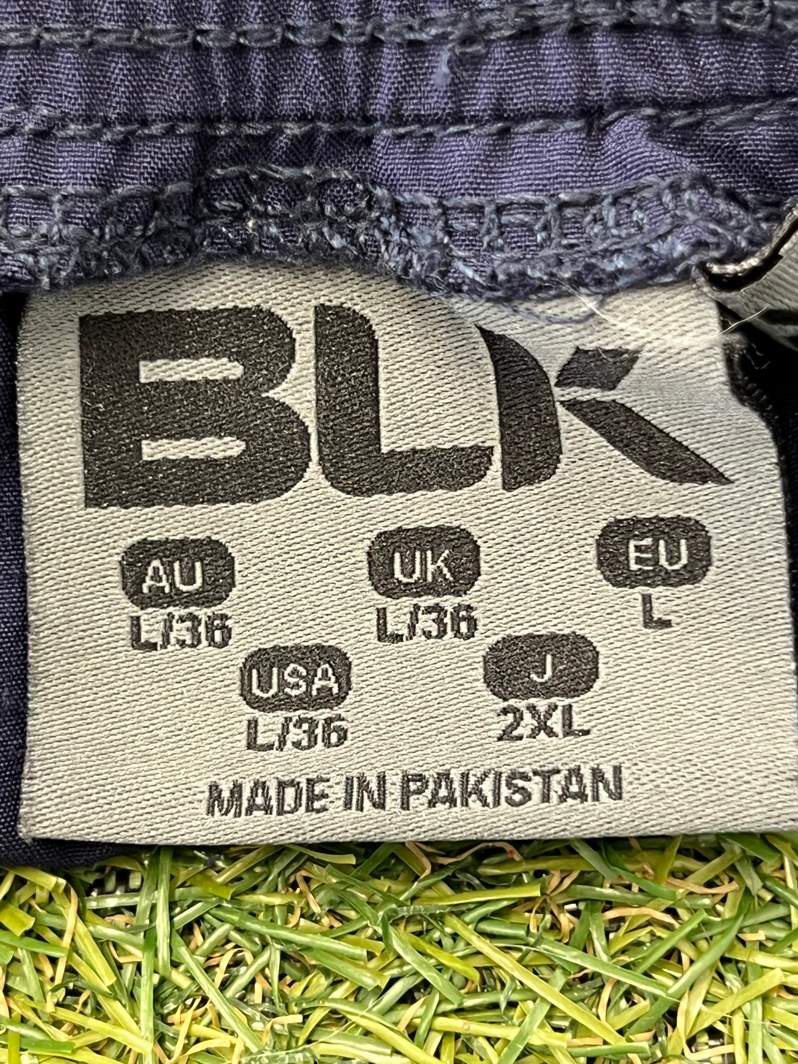 Close-up of size label inside London Irish men's training shorts by BLK showing multiple regional sizes
