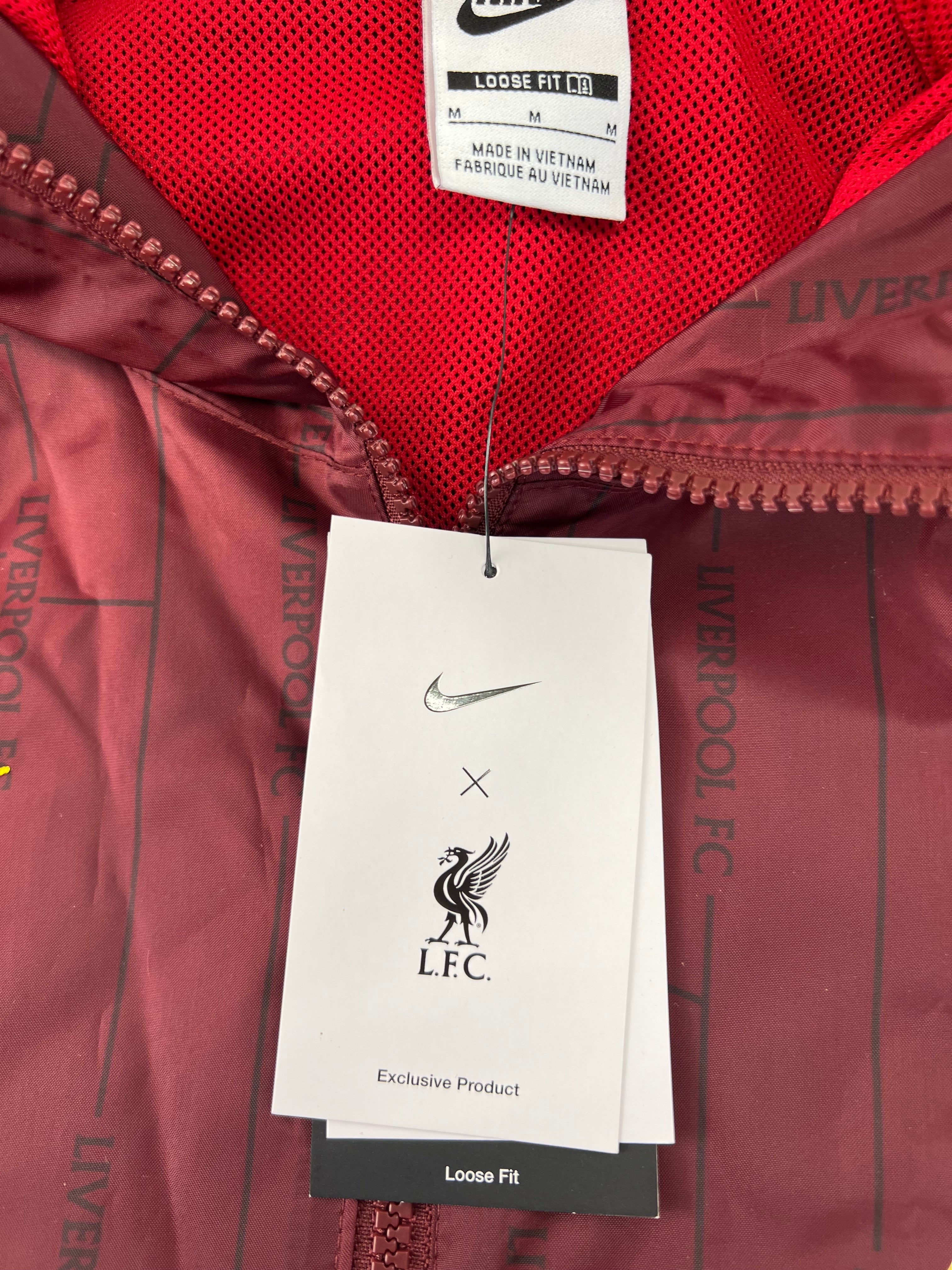 Close-up of Liverpool FC x Nike tags and sizing label inside jacket