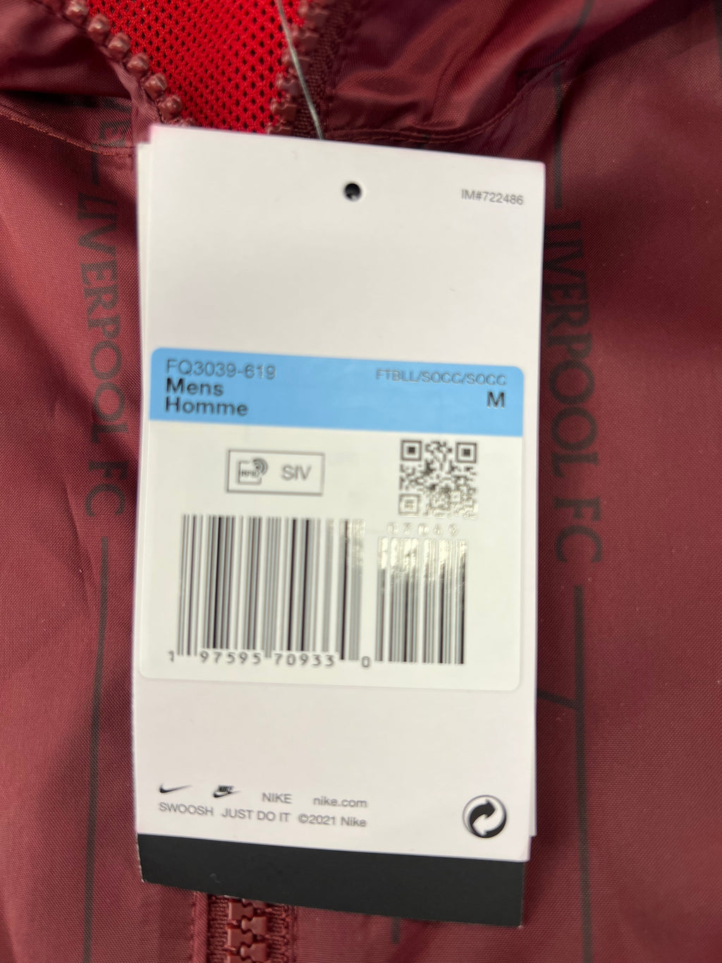Close-up of yellow Nike swoosh logo embroidered on the jacket chest