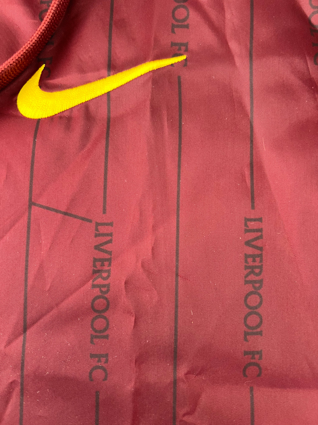 Detailed close-up of unique red fabric pattern with Liverpool FC text