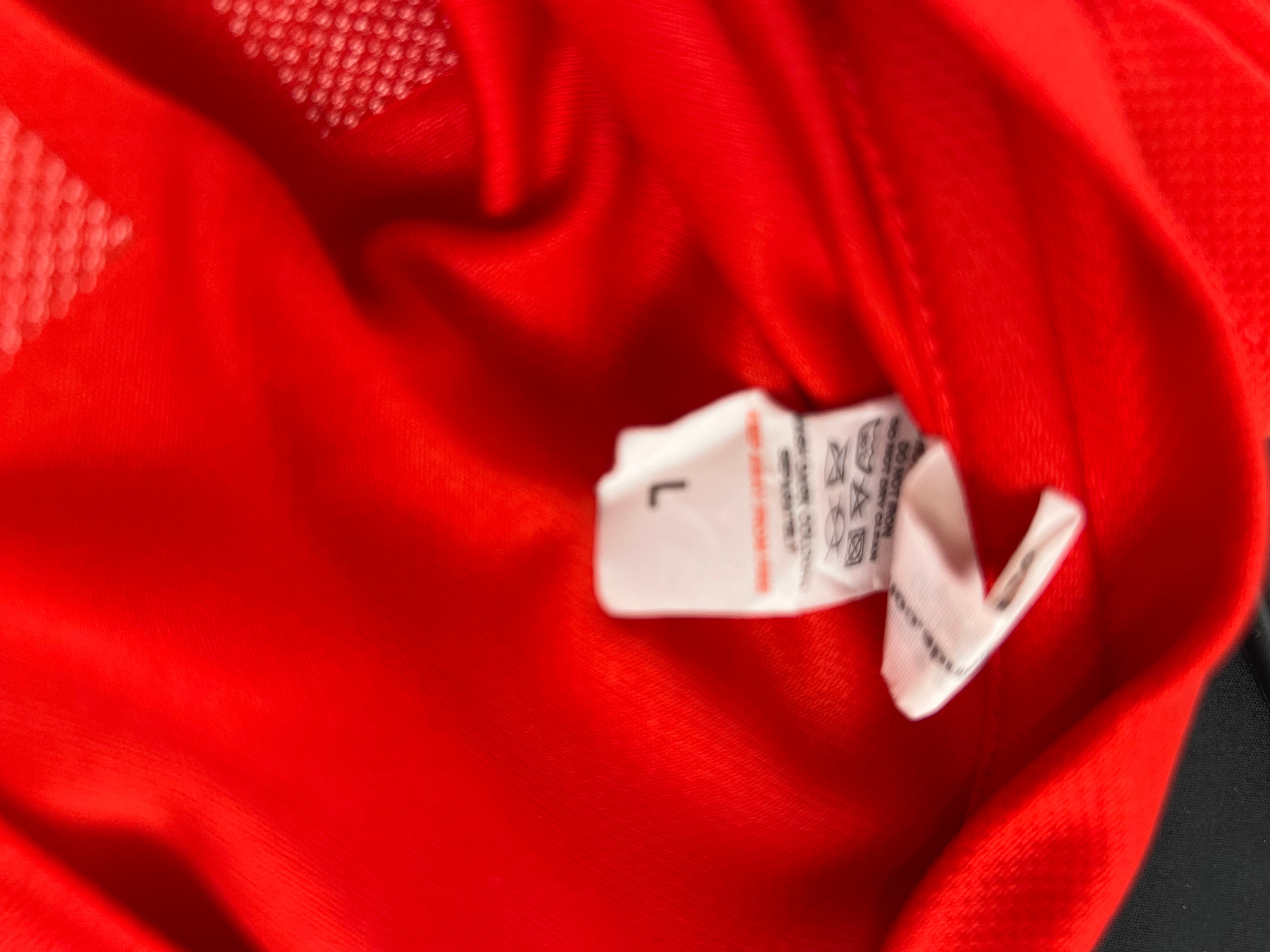 Close-up of England Rugby red T-shirt collar and size label showing Large