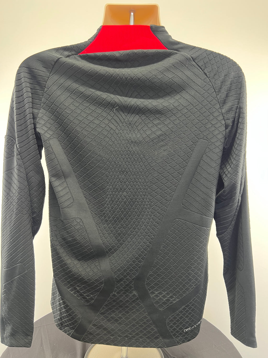 Back view of Liverpool FC long sleeve top showing detailed textured pattern and ribbed red collar