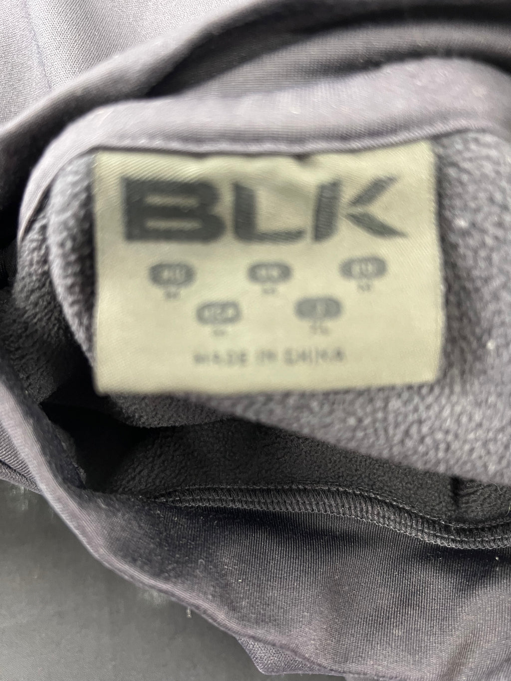 Close-up of BLK label inside London Irish sweatshirt showing product branding