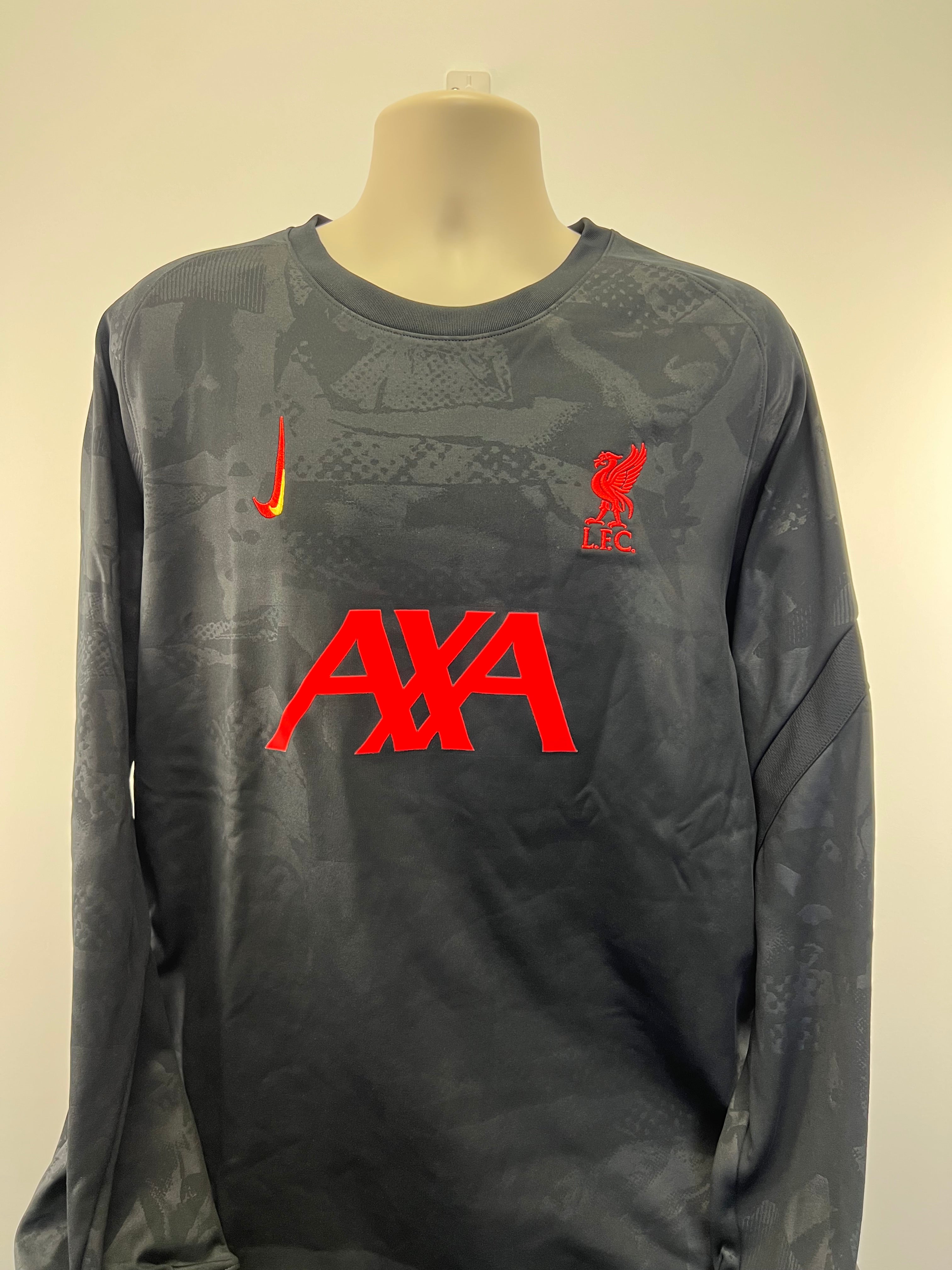 Front view of Liverpool FC long sleeve training top in black with red Liverpool crest, AXA logo, and Nike swoosh
