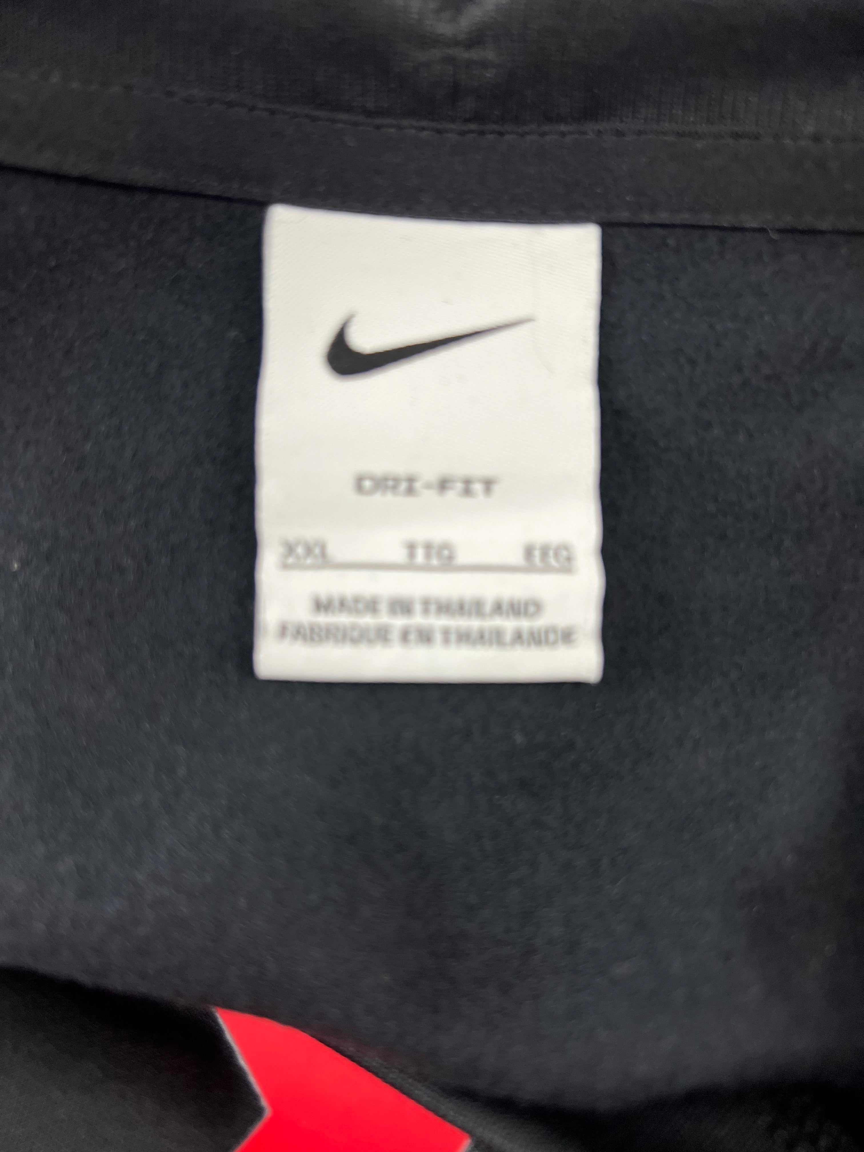 Close-up of white Nike Dri-FIT label inside Liverpool FC training top showing size XXL made in Thailand