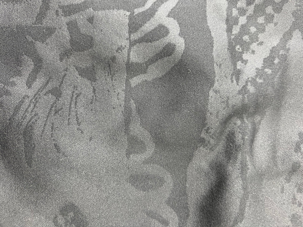 Detailed close-up of subtle tonal graphic pattern on black fabric of Liverpool FC training top