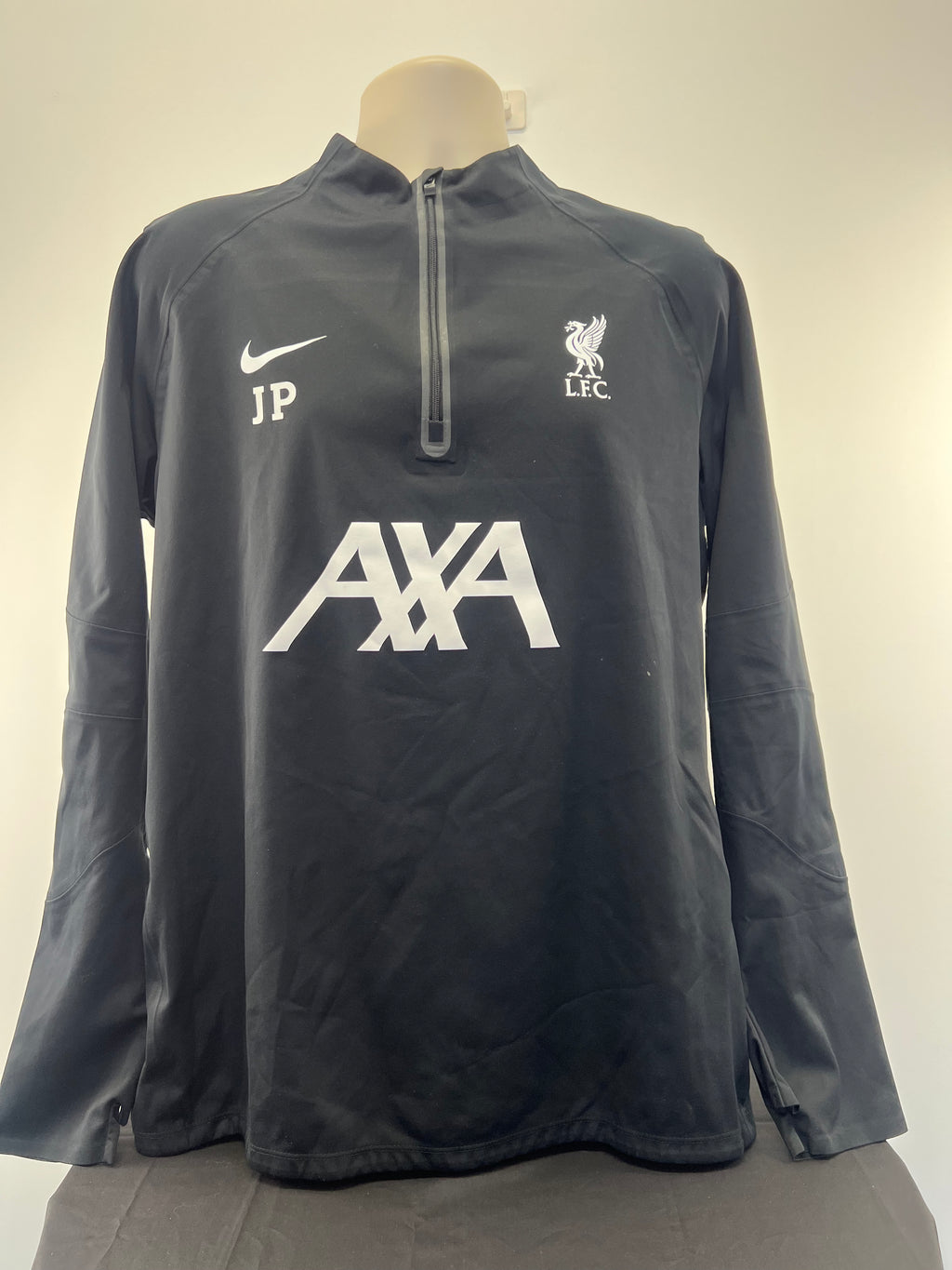 Front view of black Liverpool FC Nike long sleeve training top featuring club crest, Nike logo, AXA sponsorship and JP initials