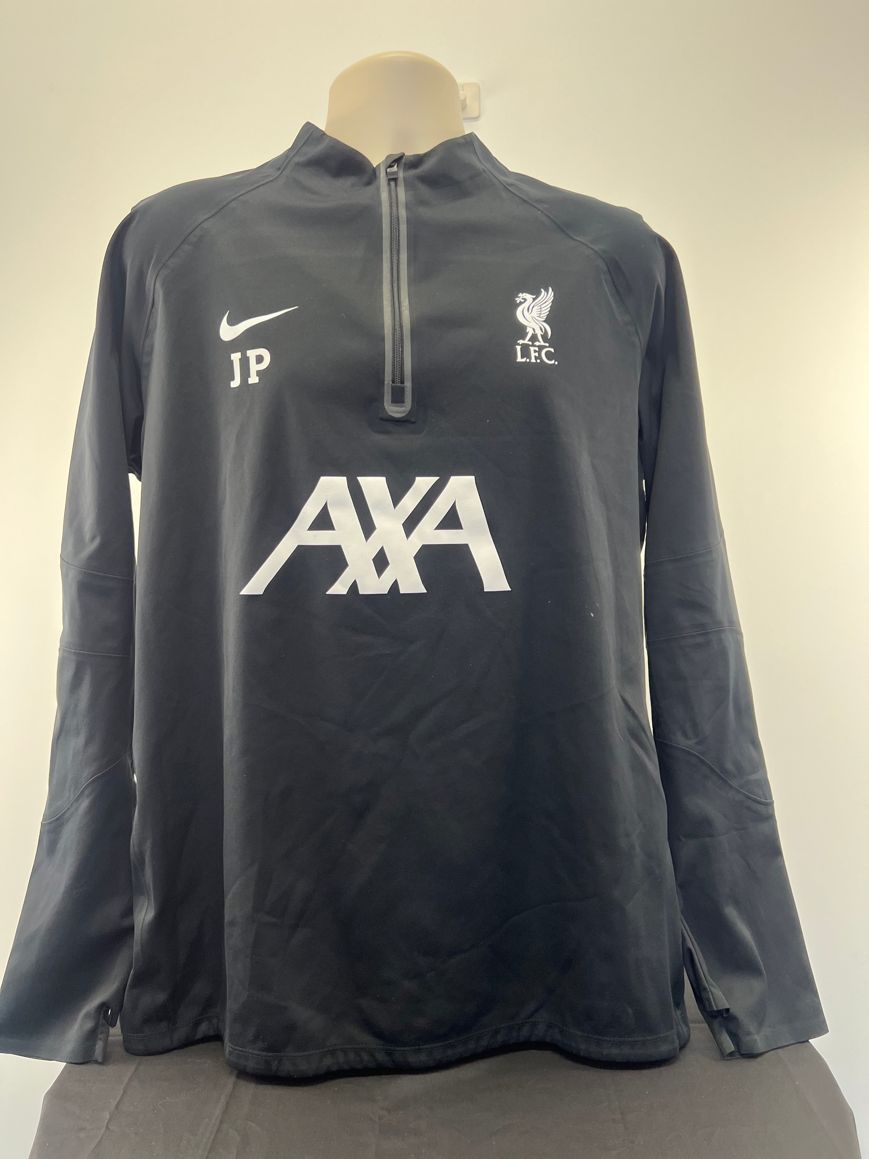 Front view of black Liverpool FC Nike long sleeve training top featuring club crest, Nike logo, AXA sponsorship and JP initials