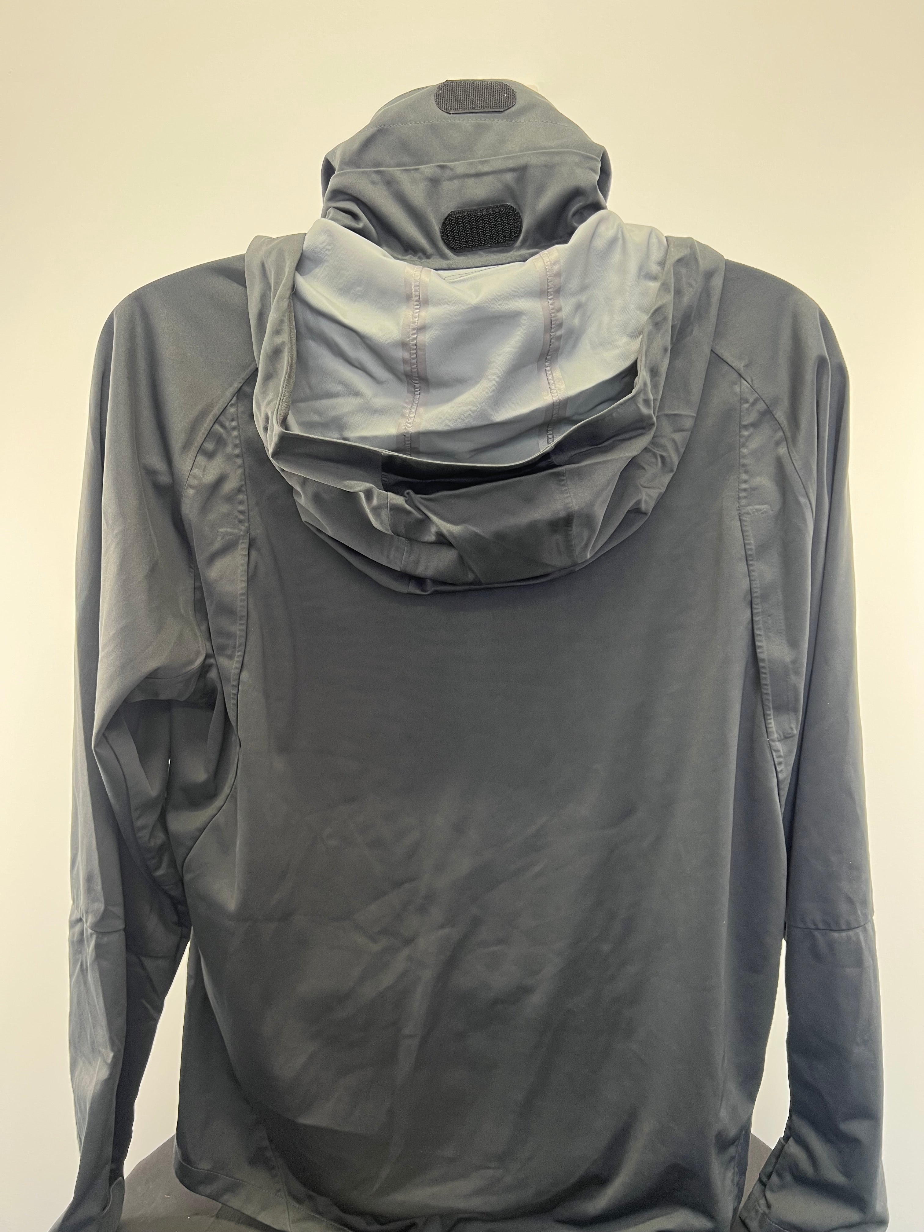 Back view of Liverpool FC dark grey Nike Storm-FIT jacket showing hood with Velcro adjustment