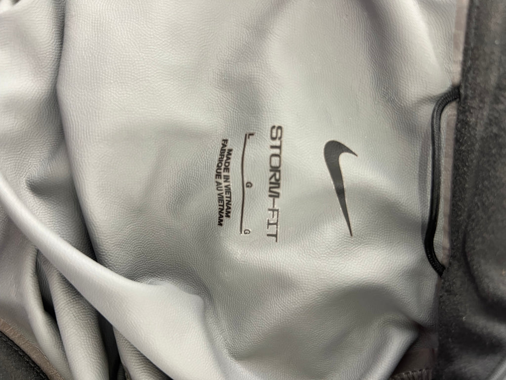 Close-up of interior label showing Nike logo, Storm-FIT technology and size Large indication