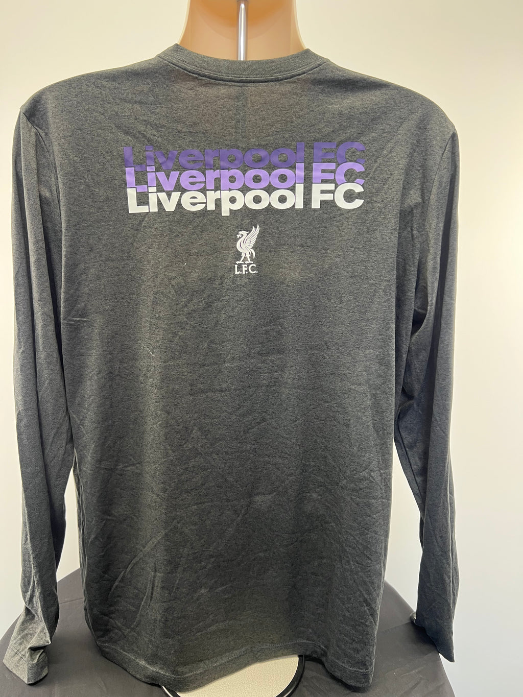 Back view of Liverpool FC long sleeve shirt showing Liverpool FC repeated text and Liverbird logo in white and purple