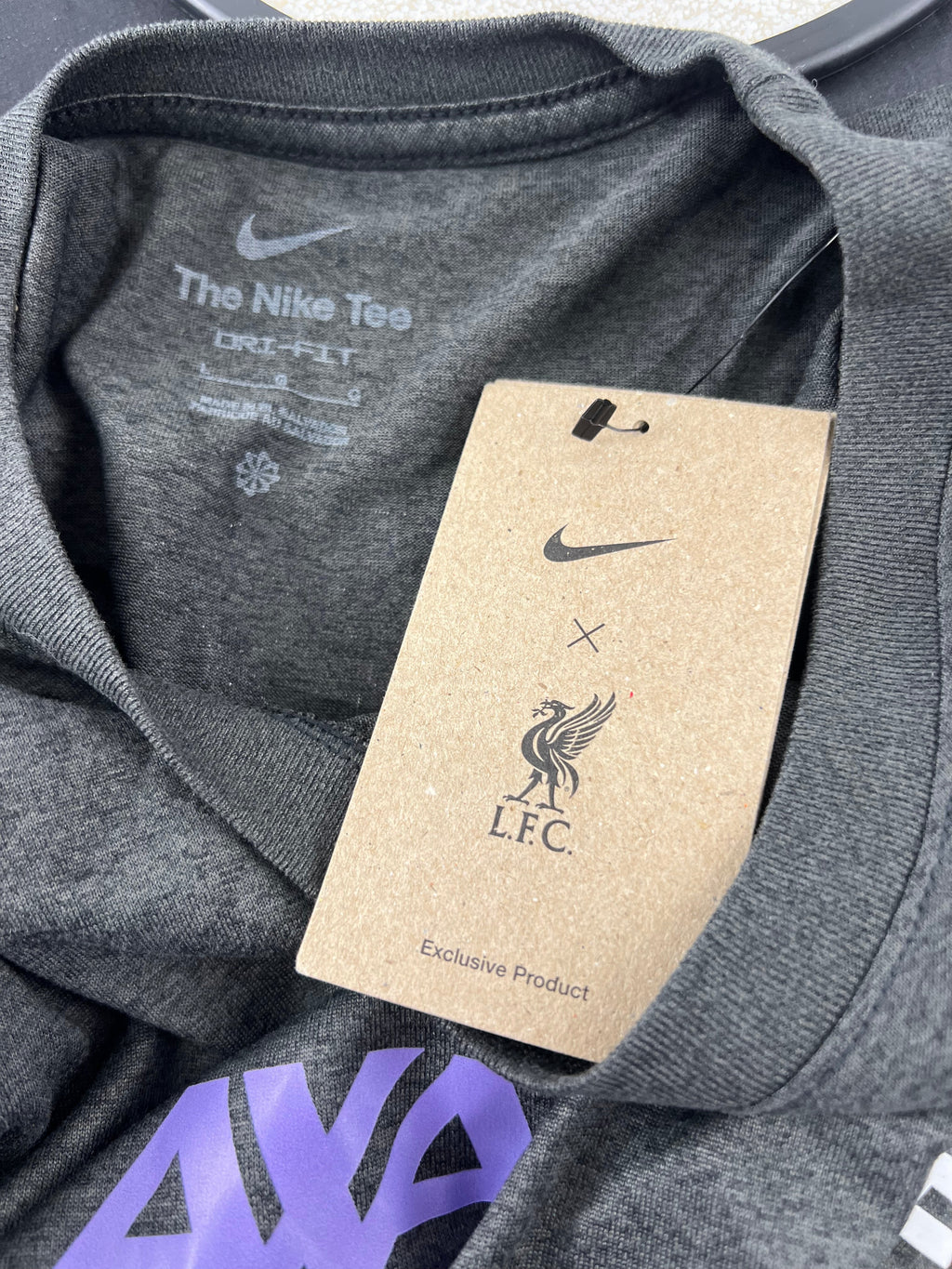 Close-up of Liverpool FC and Nike logo tag attached to the long sleeve shirt