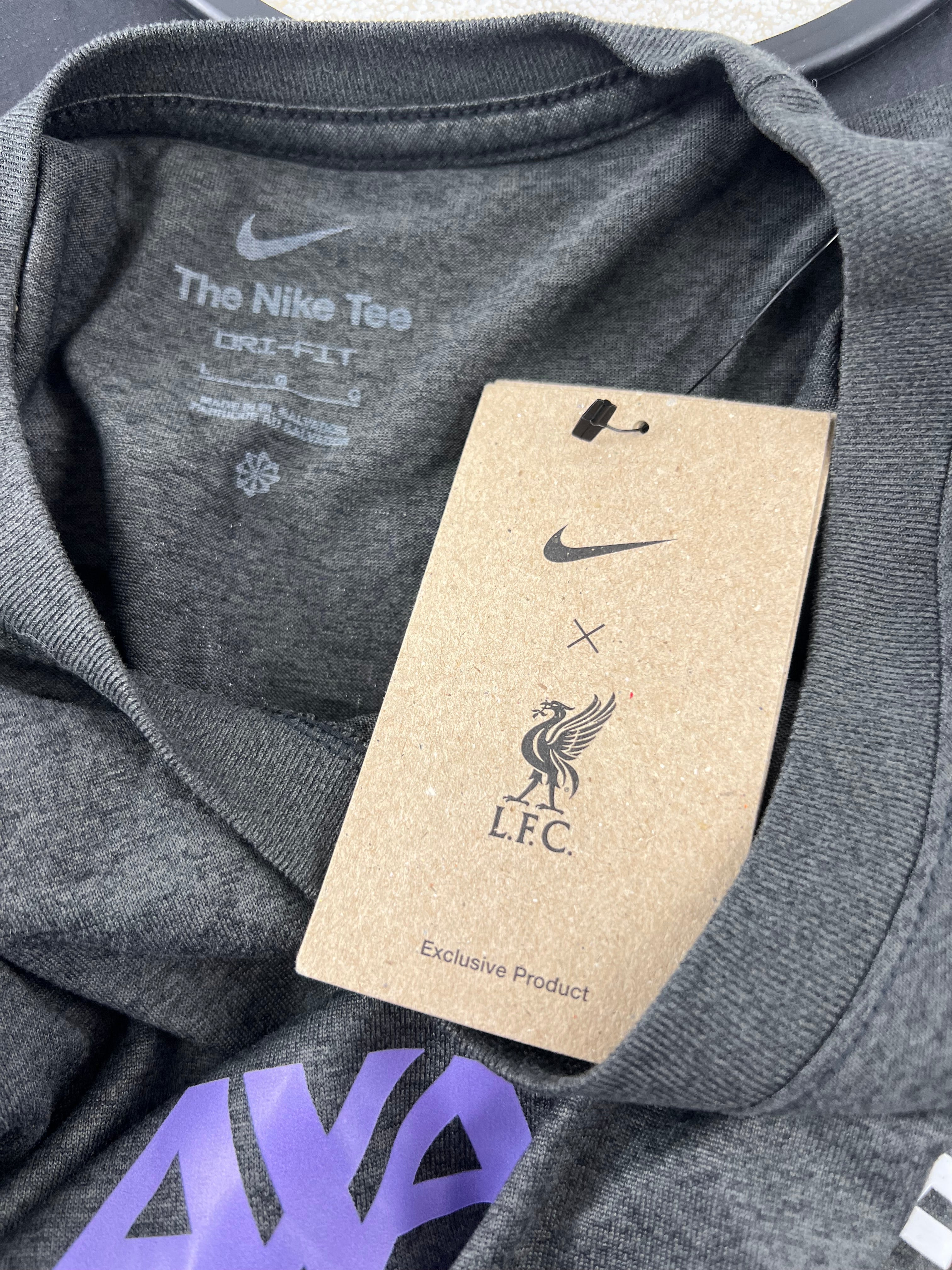 Close-up of Liverpool FC and Nike logo tag attached to the long sleeve shirt