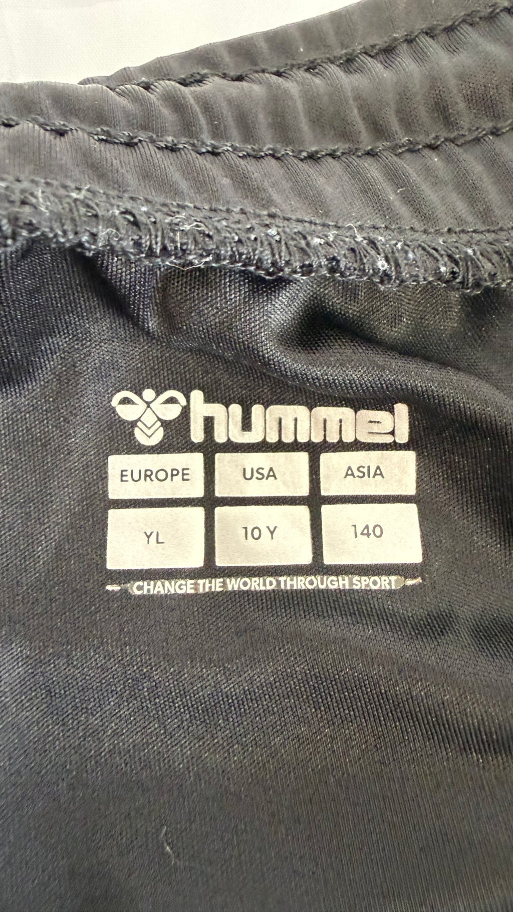 Hummel size label inside Everton kids football shorts showing youth large