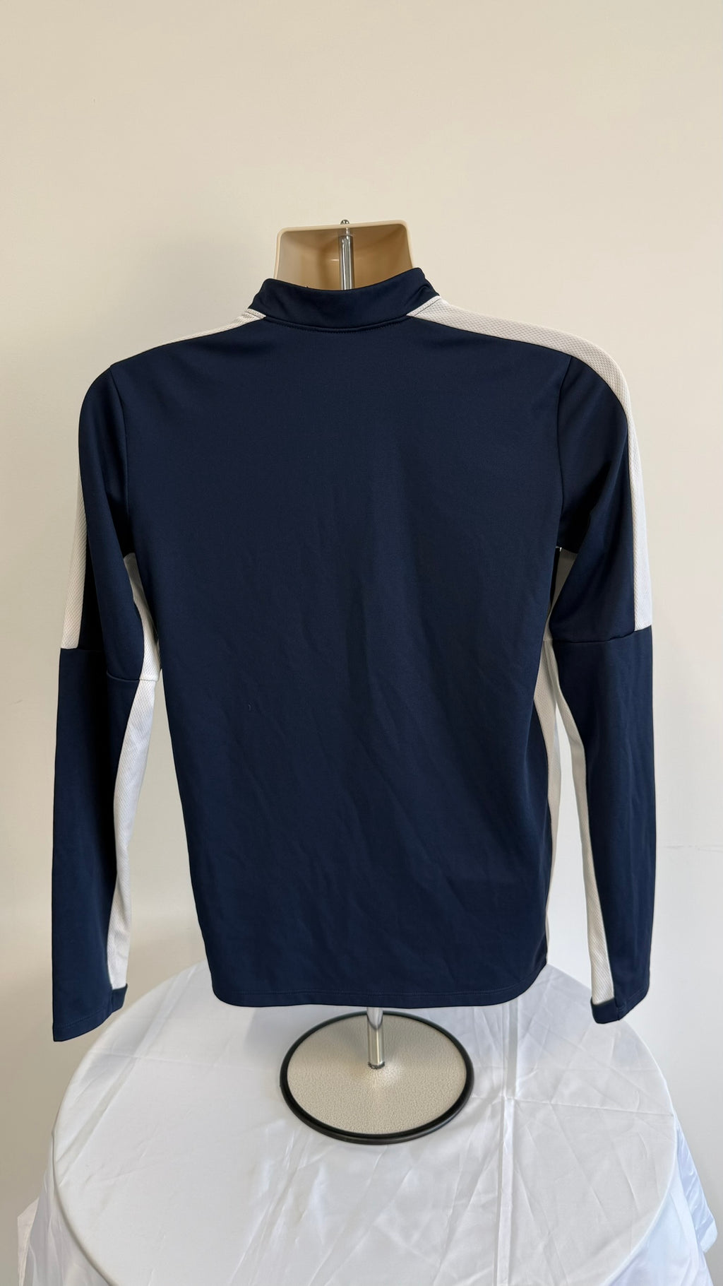 Back view of Nike Chelsea Foundation long sleeve training top showing solid navy blue colour and side white panels