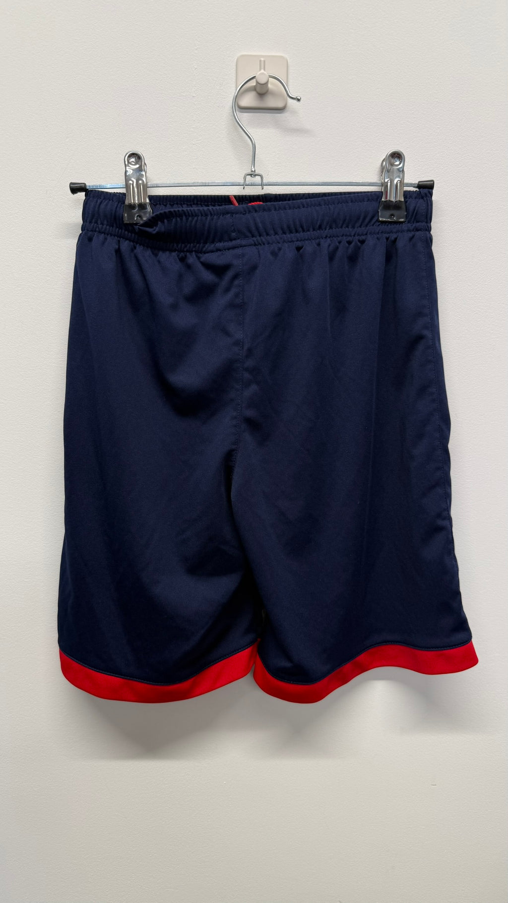 Back view of PSG kids navy shorts with red trim