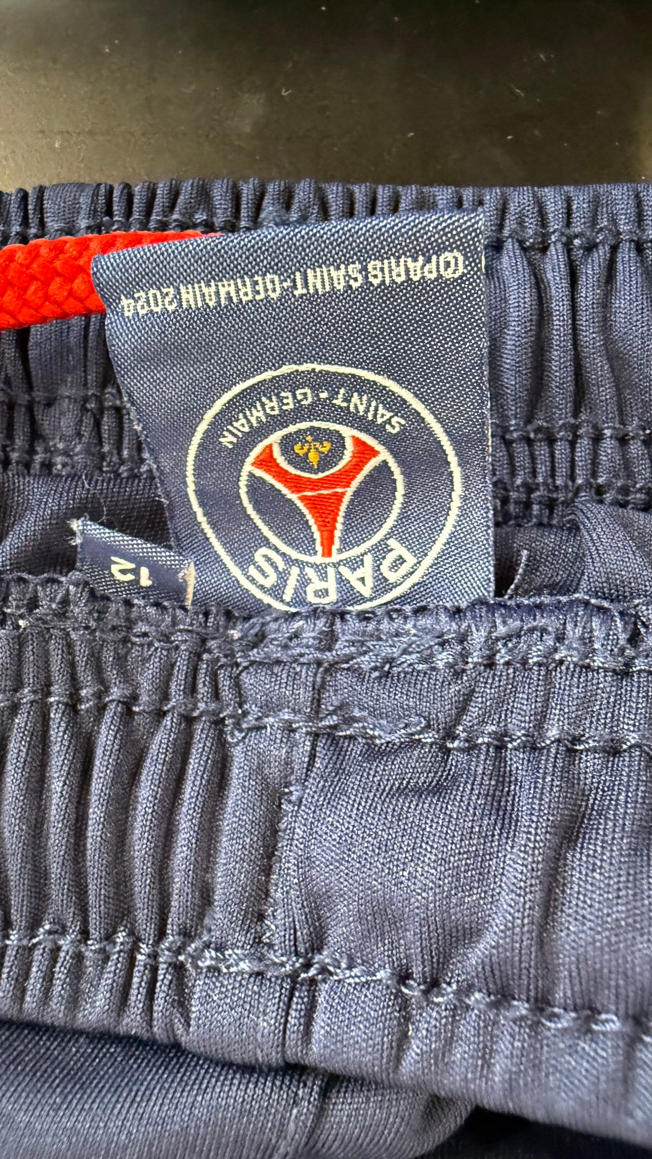 Close-up of PSG shorts waistband with official club tag and size label