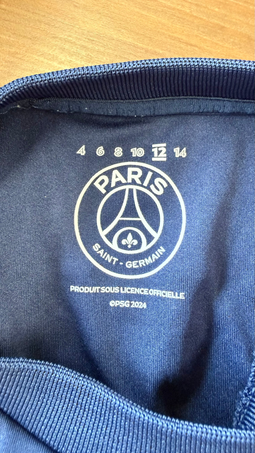 Inside neckline view showing PSG official license and size label