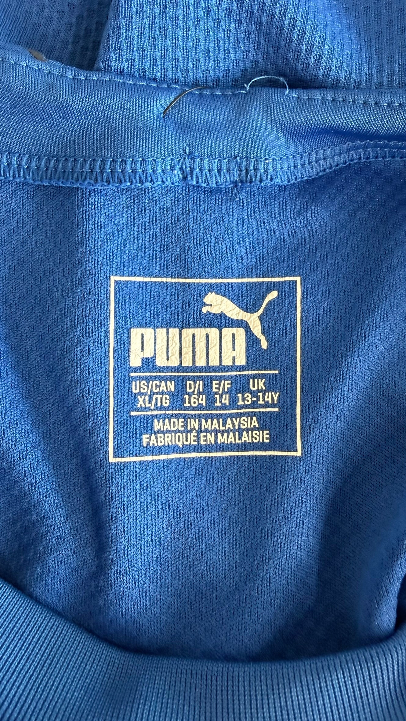 Size label inside Puma Italy kids football shirt showing age 13-14 years
