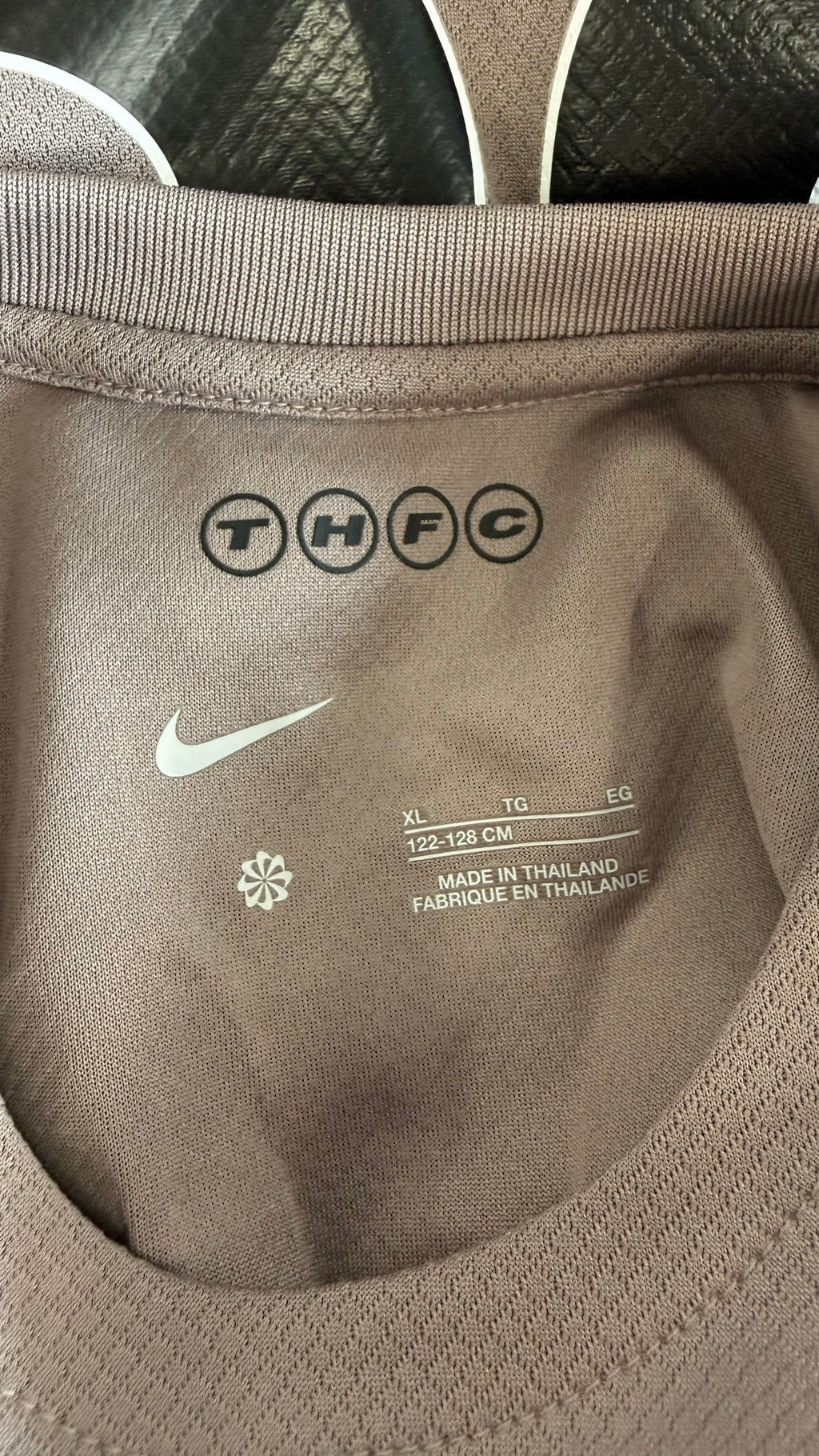 Close-up of size label and collar details on Tottenham Hotspur kids shirt