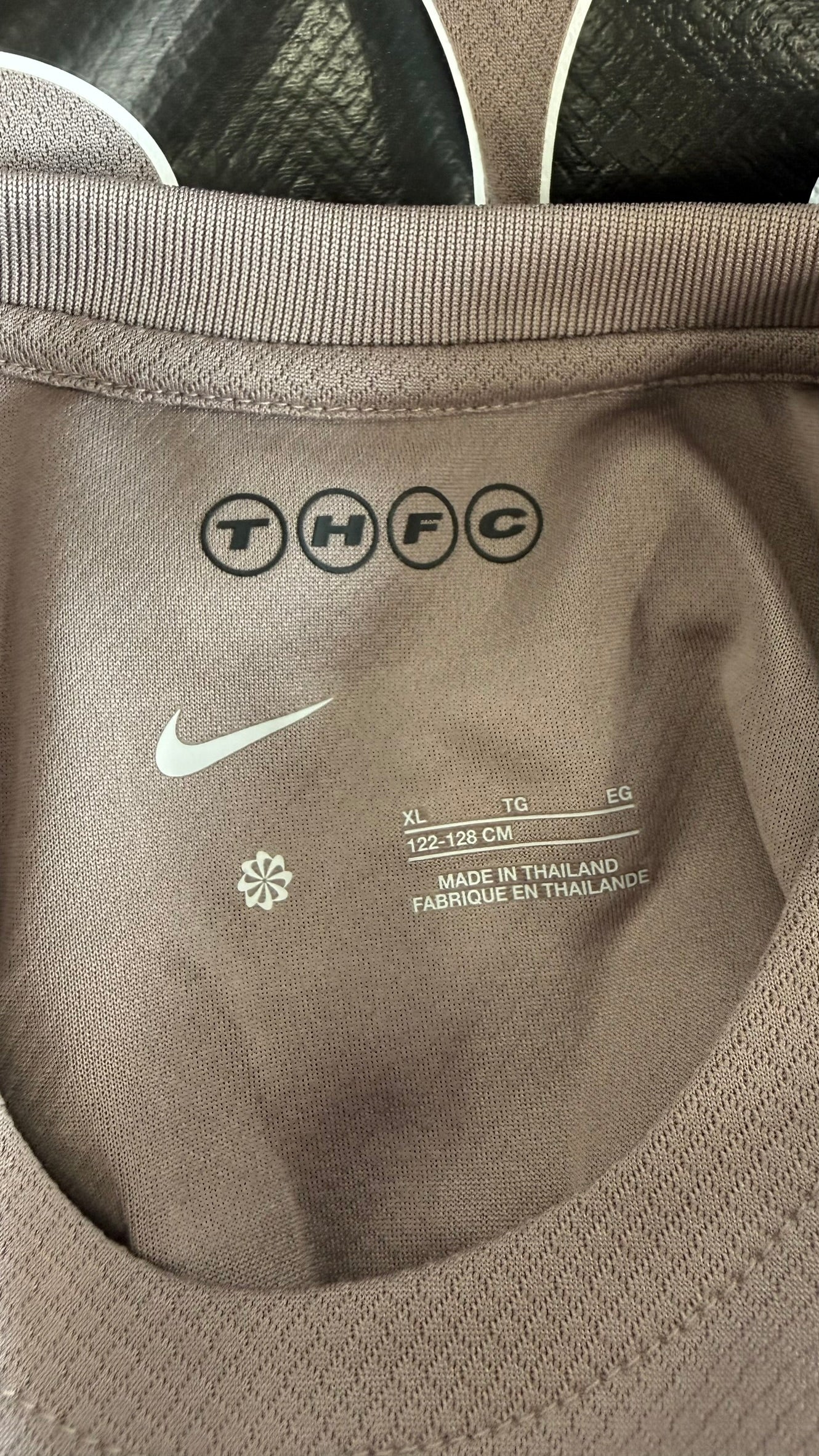 Close-up of size label and collar details on Tottenham Hotspur kids shirt