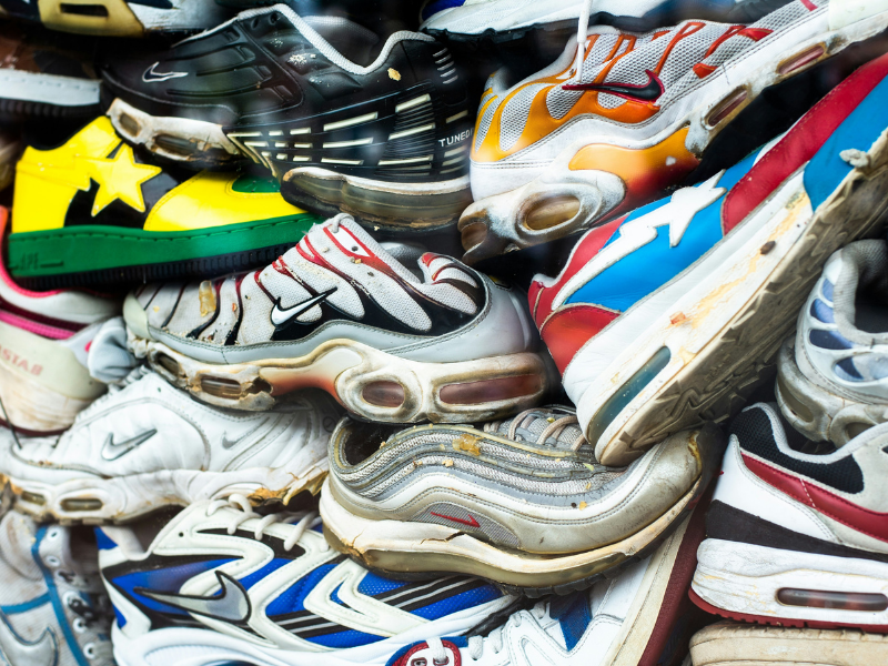 A pile of running shoes that have been discarded