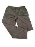 BenRoss black golf trousers with elastic waistband and adjustable Velcro ankle straps laid flat on green grassy surface