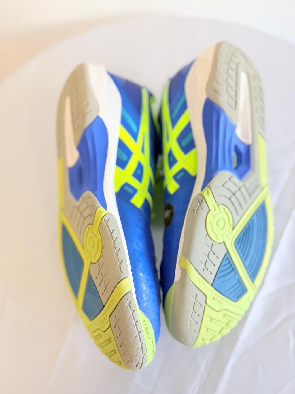 ASICS indoor court shoes showing non-marking outsoles