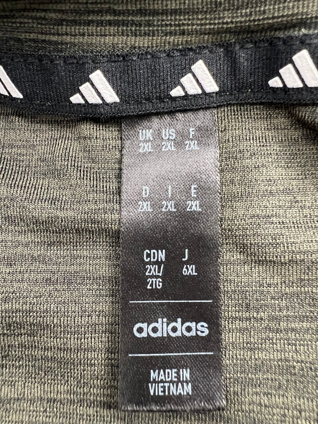 Close-up of adidas tag showing size 2XL and made in Vietnam details